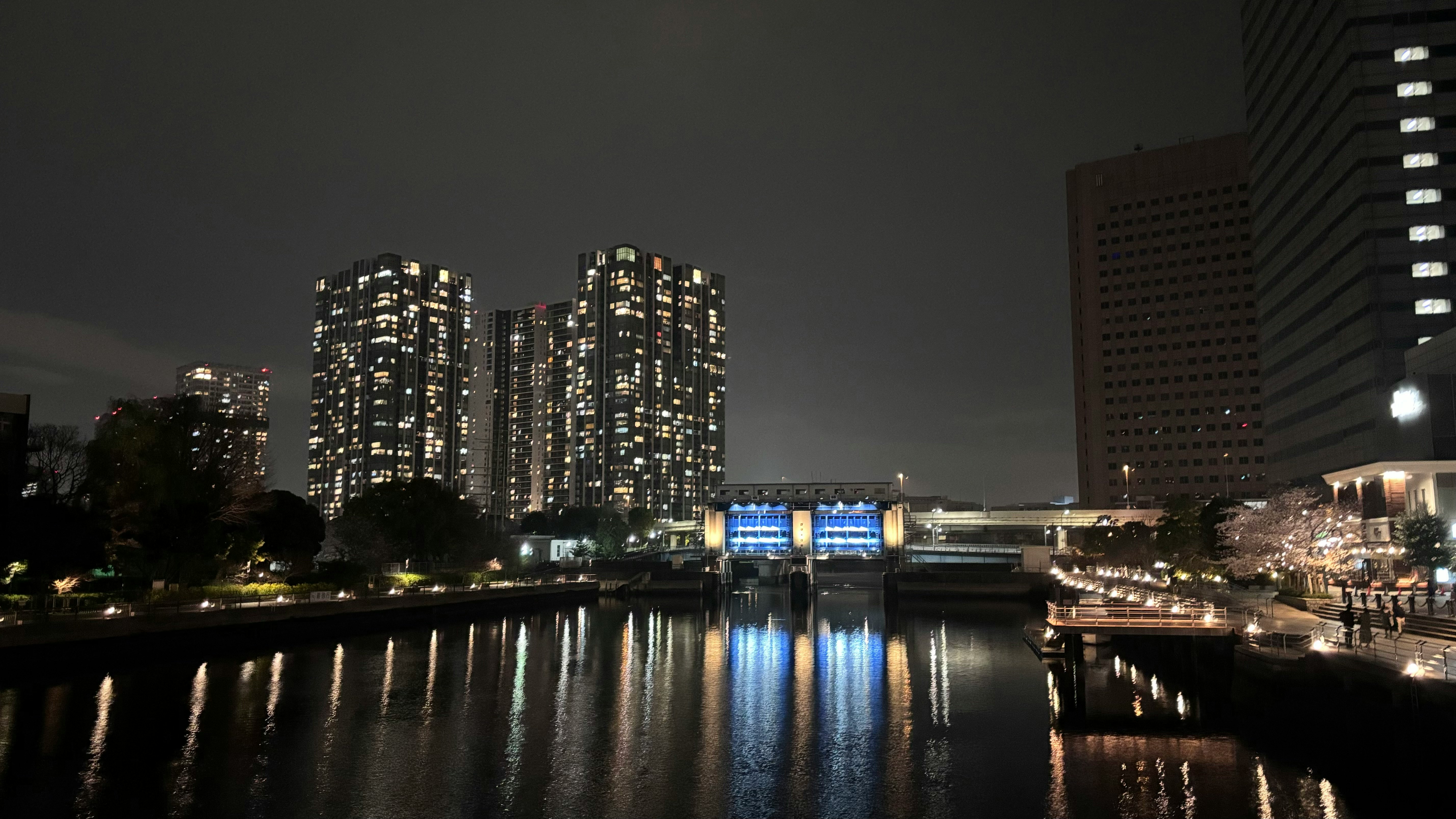 川面に映る夜景と高層ビルの並ぶ都市の風景