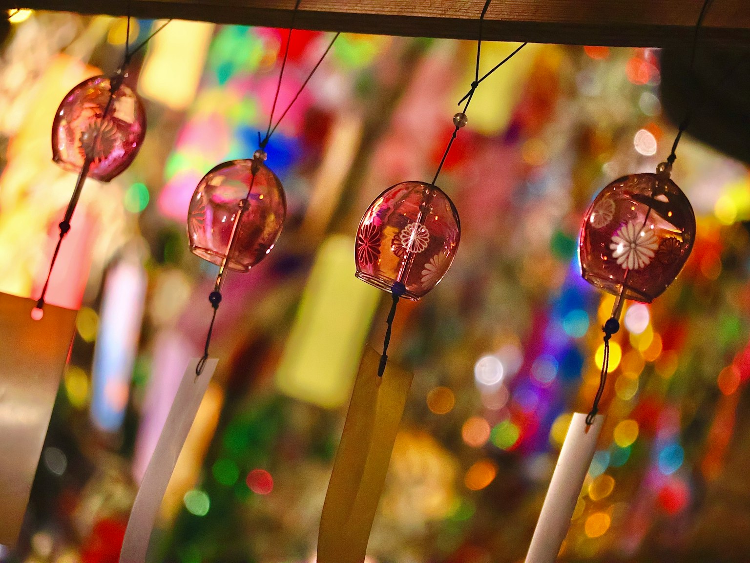 Colorful wind chimes hanging in a vibrant display