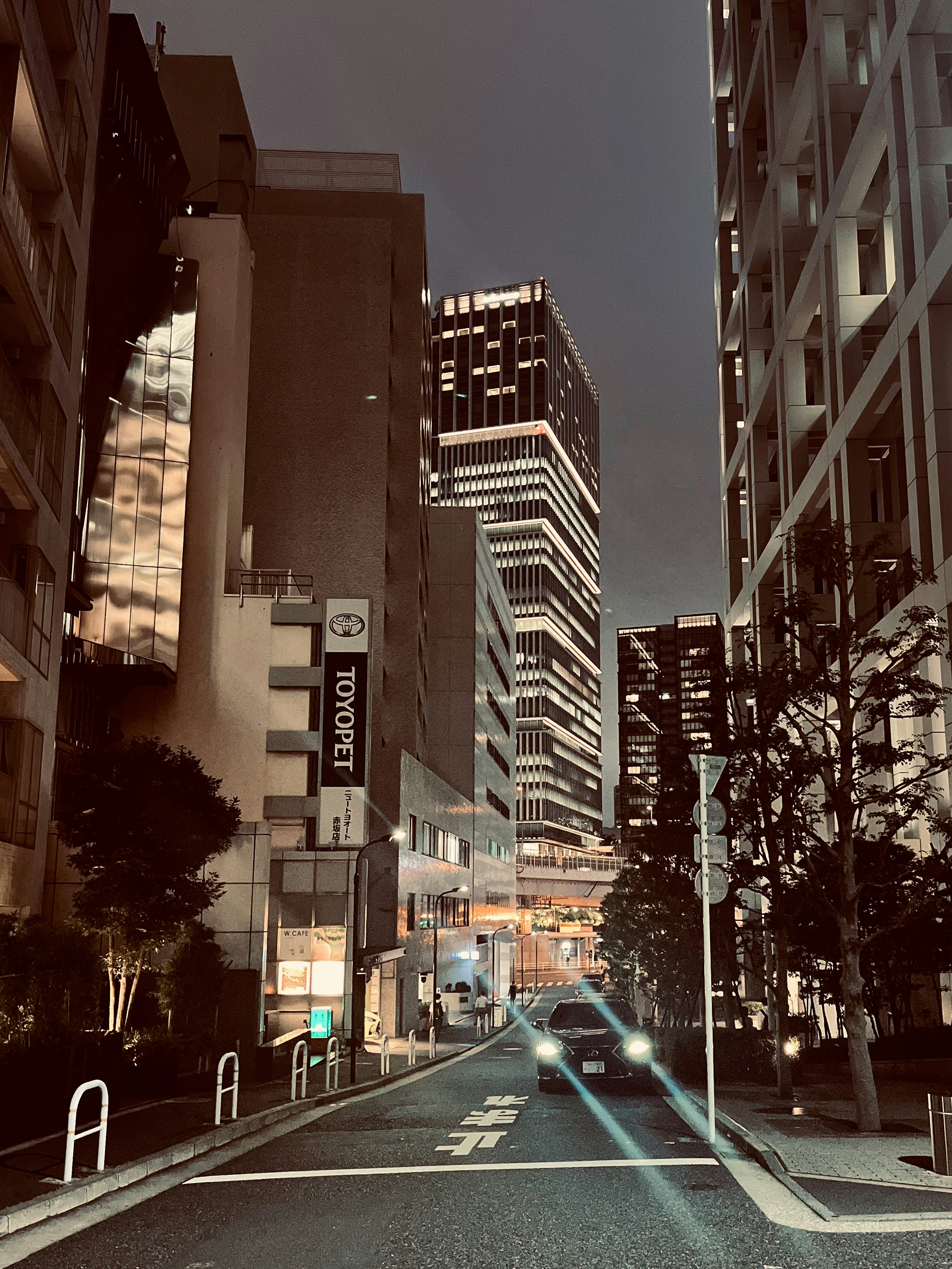 Una strada notturna ad Akasaka con edifici e auto