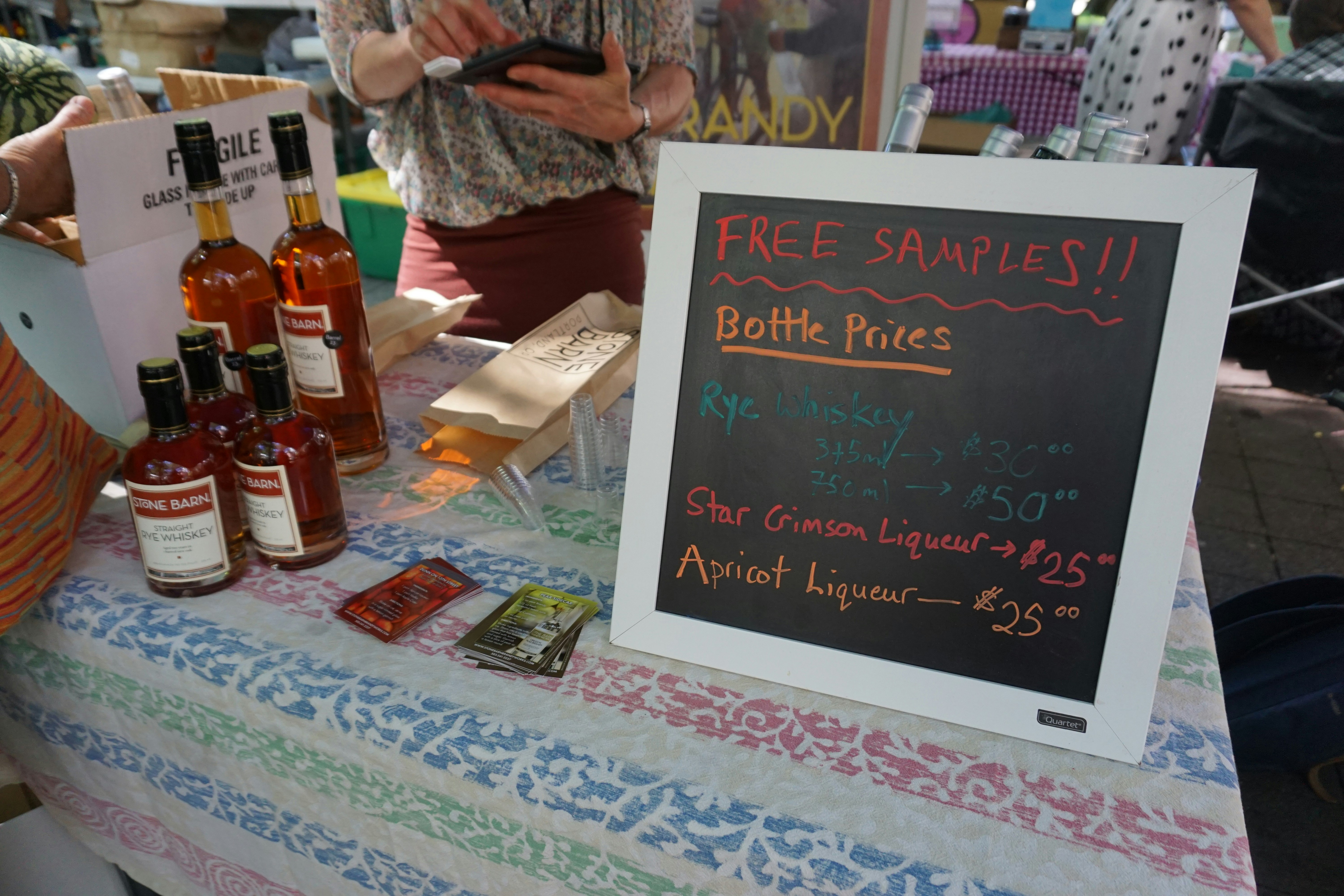 table display of bottles with a “FREE SAMPLES!!” sign