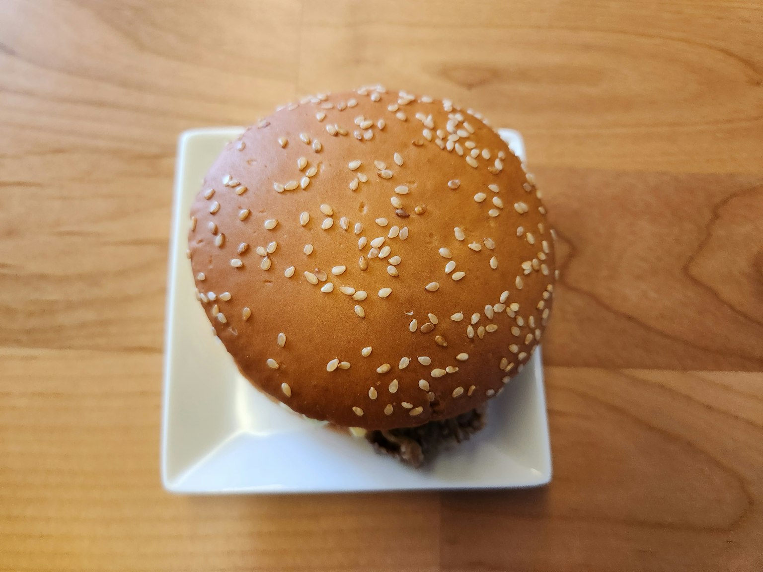 Hamburger với bánh sesame trên đĩa trắng