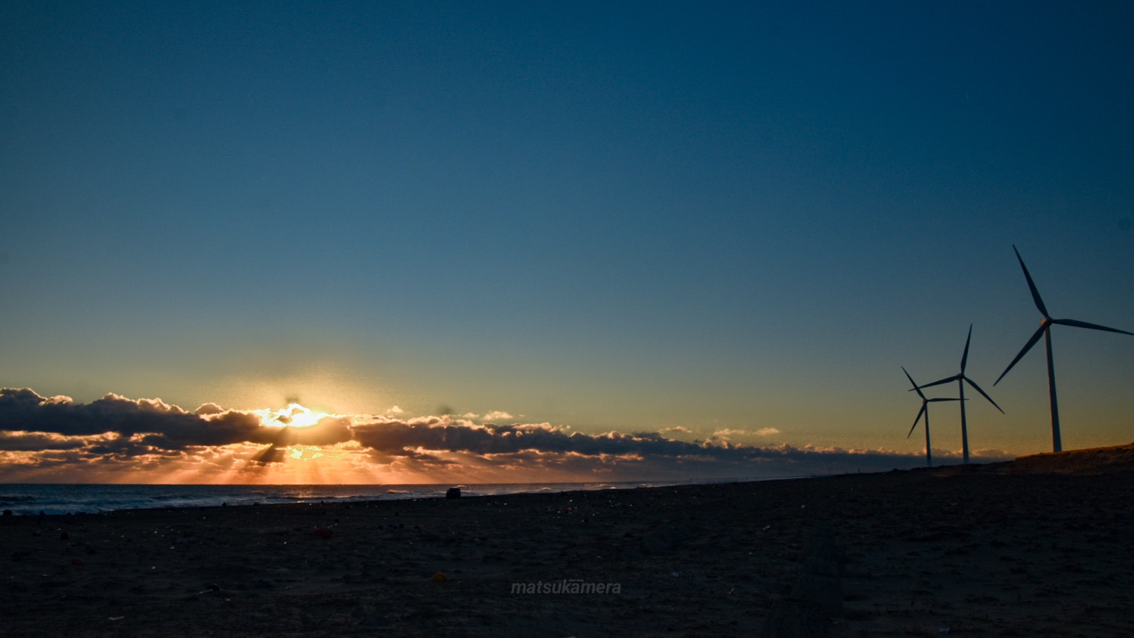 dusk seaside landscape with wind turbines