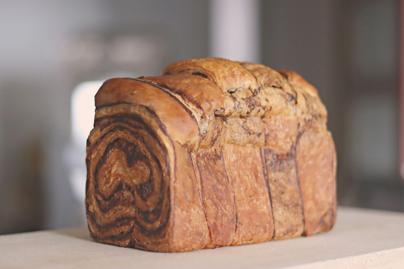 A delicious chocolate marble bread sitting on a wooden counter