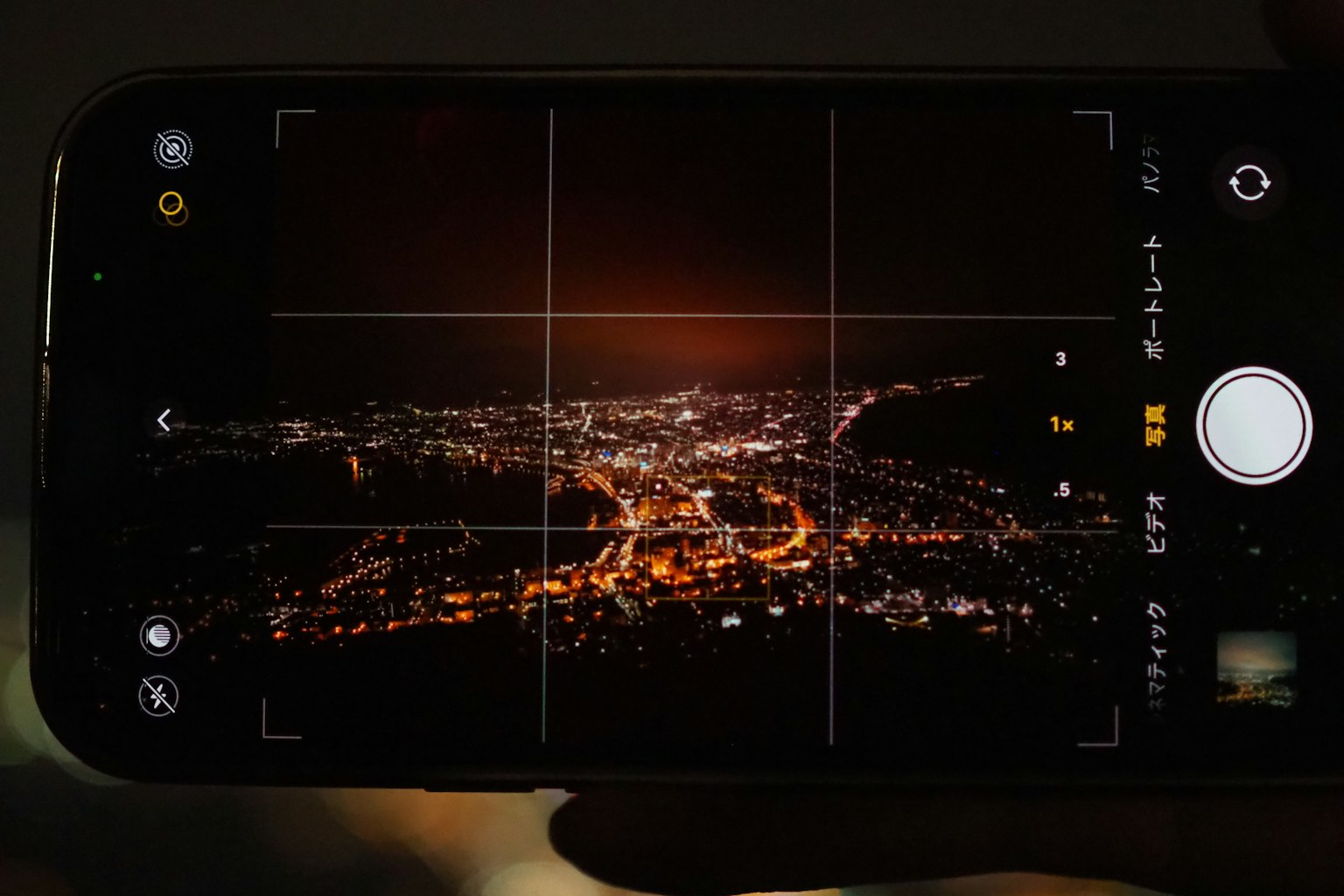 Smartphone camera app displaying a cityscape at night