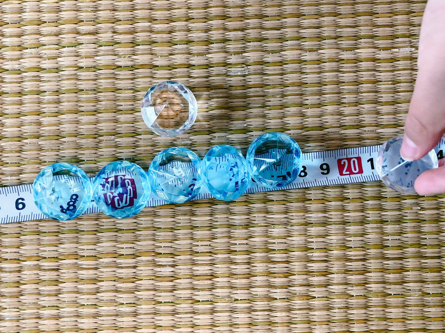 Blue circular objects arranged on a measuring tape