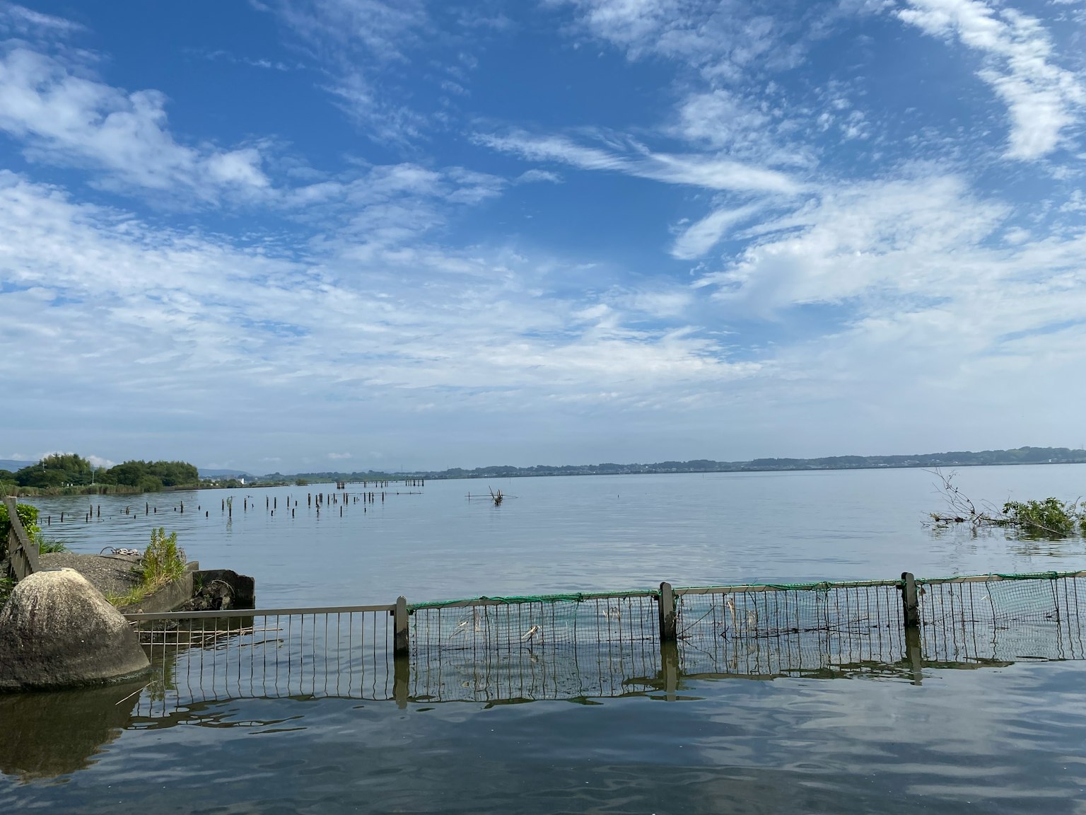 Pemandangan danau yang tenang dengan langit biru yang luas