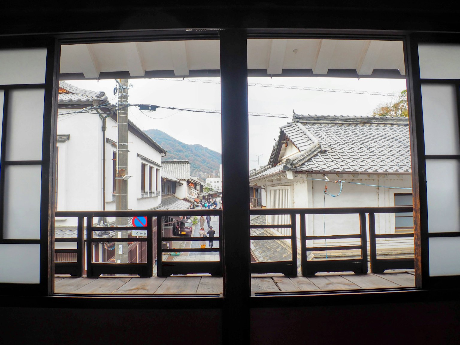 透过窗户看到的传统日本街道和山脉风景