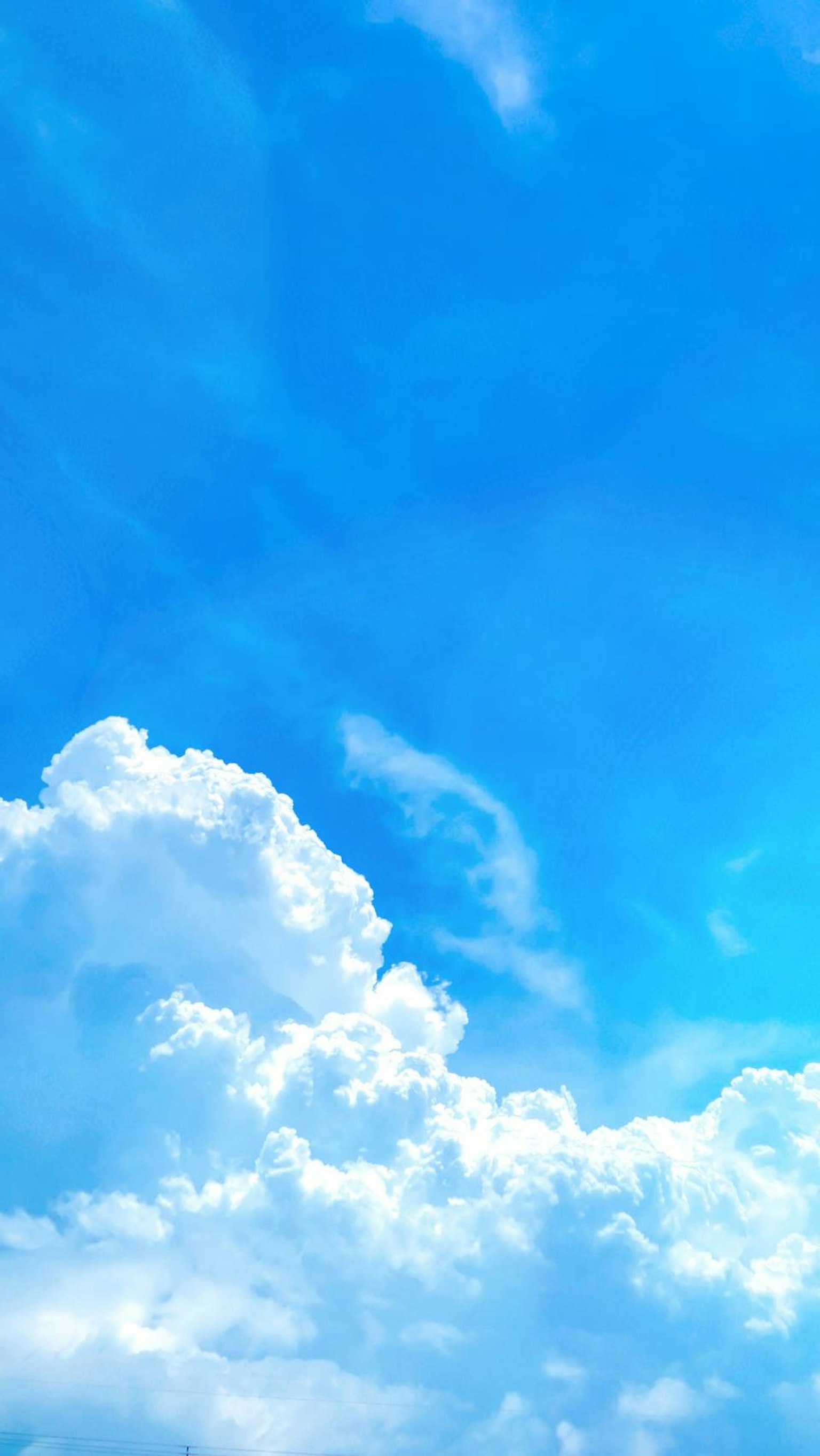 A beautiful landscape with a blue sky and white clouds