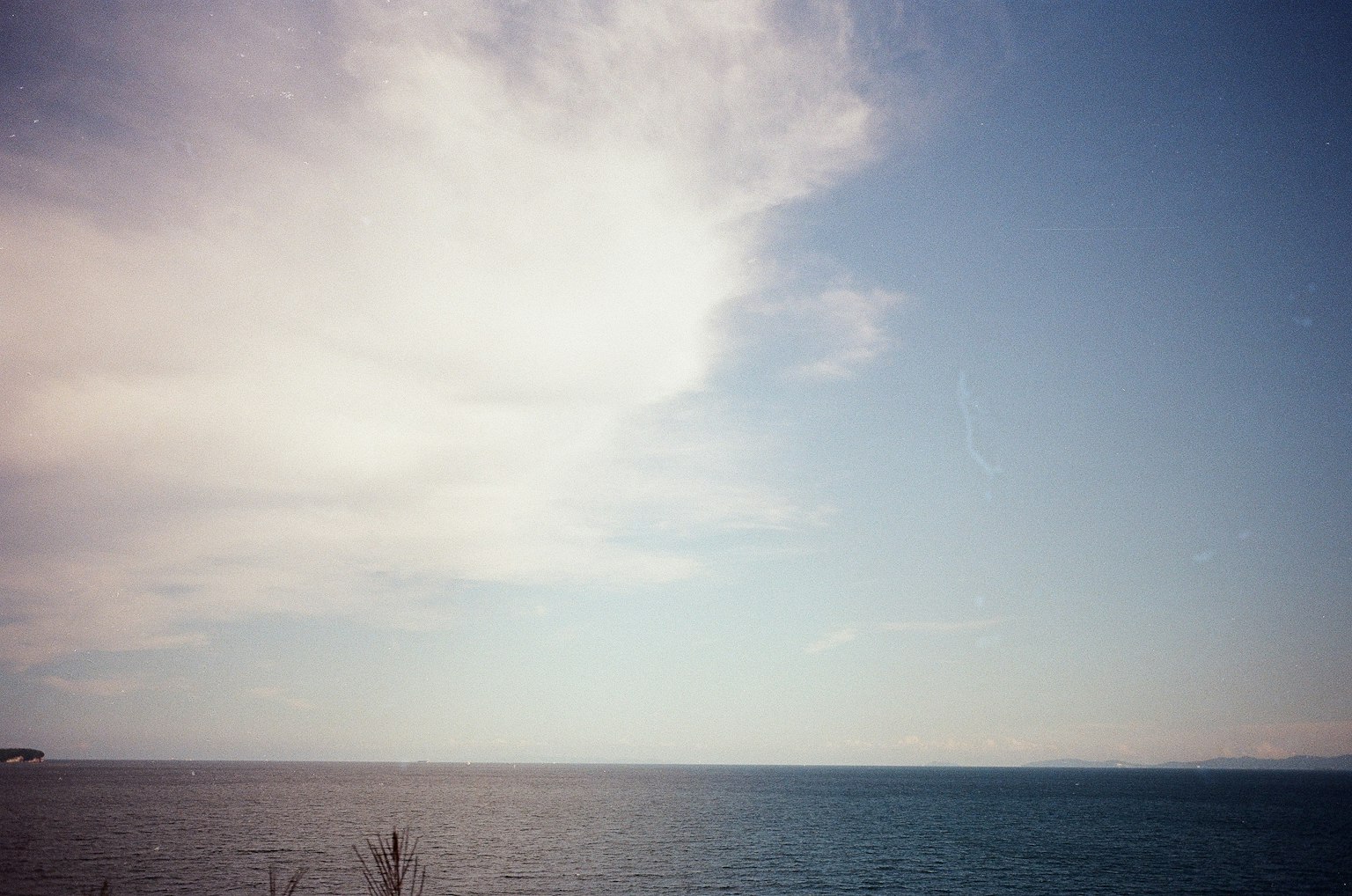 A serene view of the ocean and sky with clouds