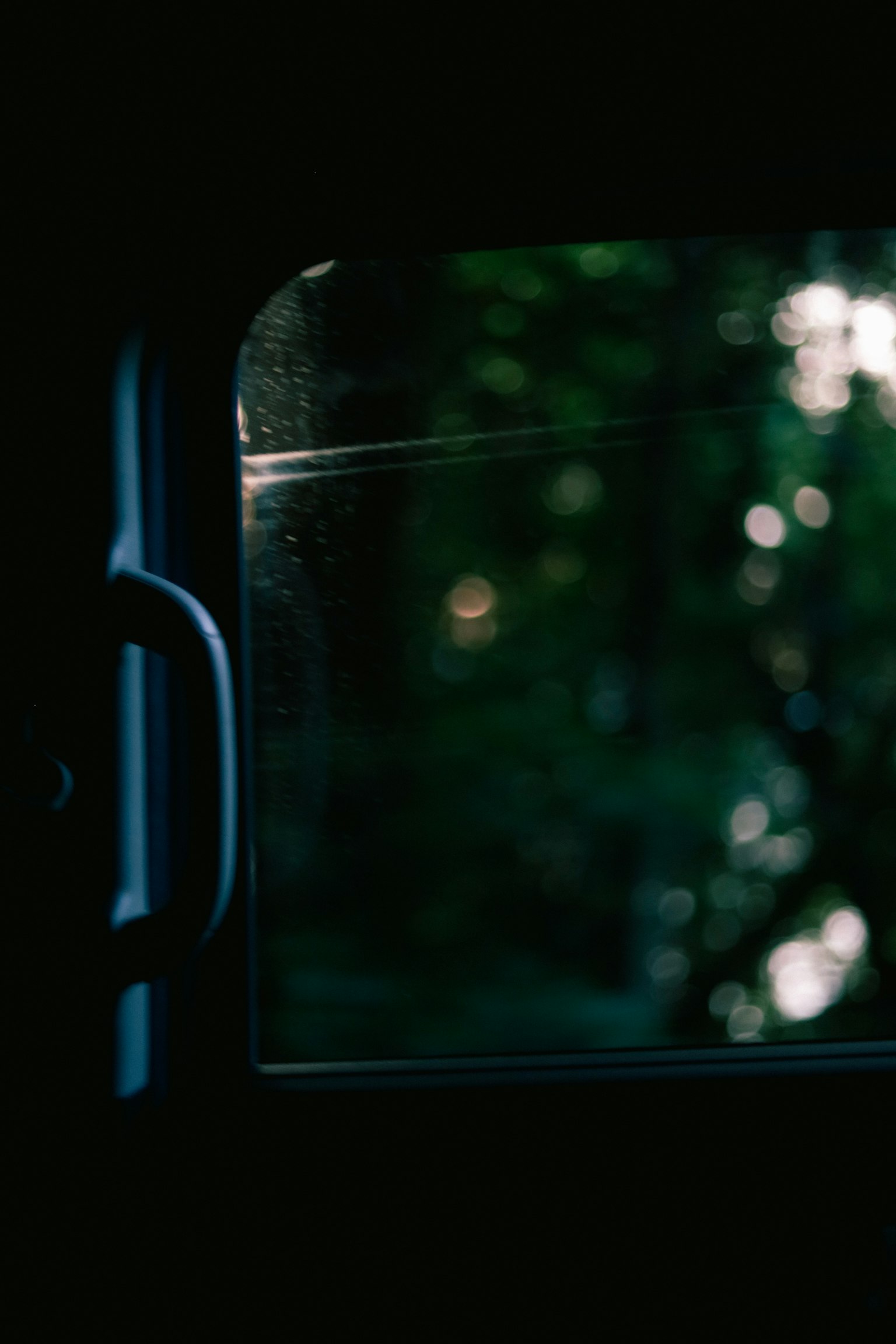 Dark scene near a window with a green background