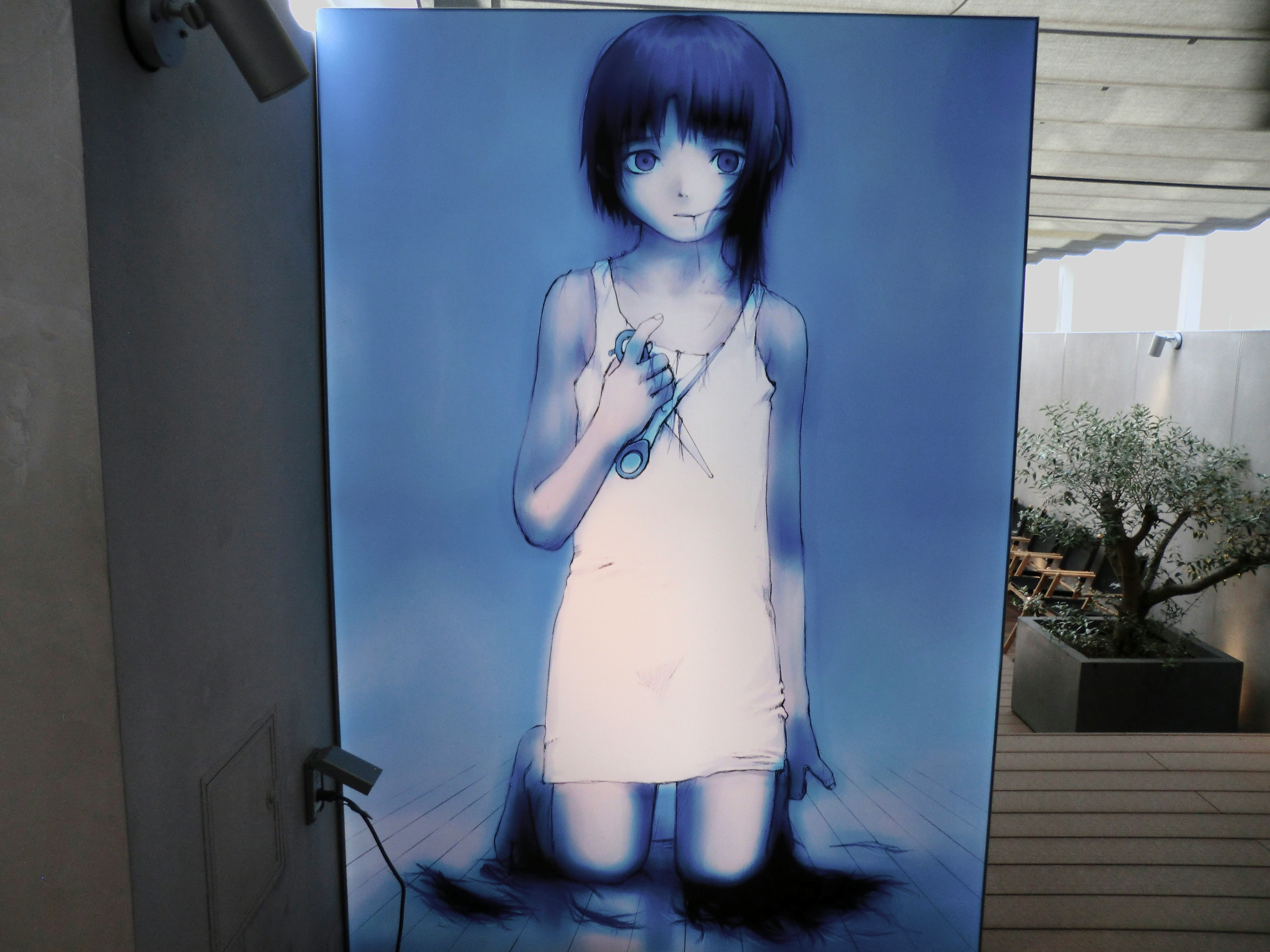 青い光の演出で立つ少女のイラストパネル