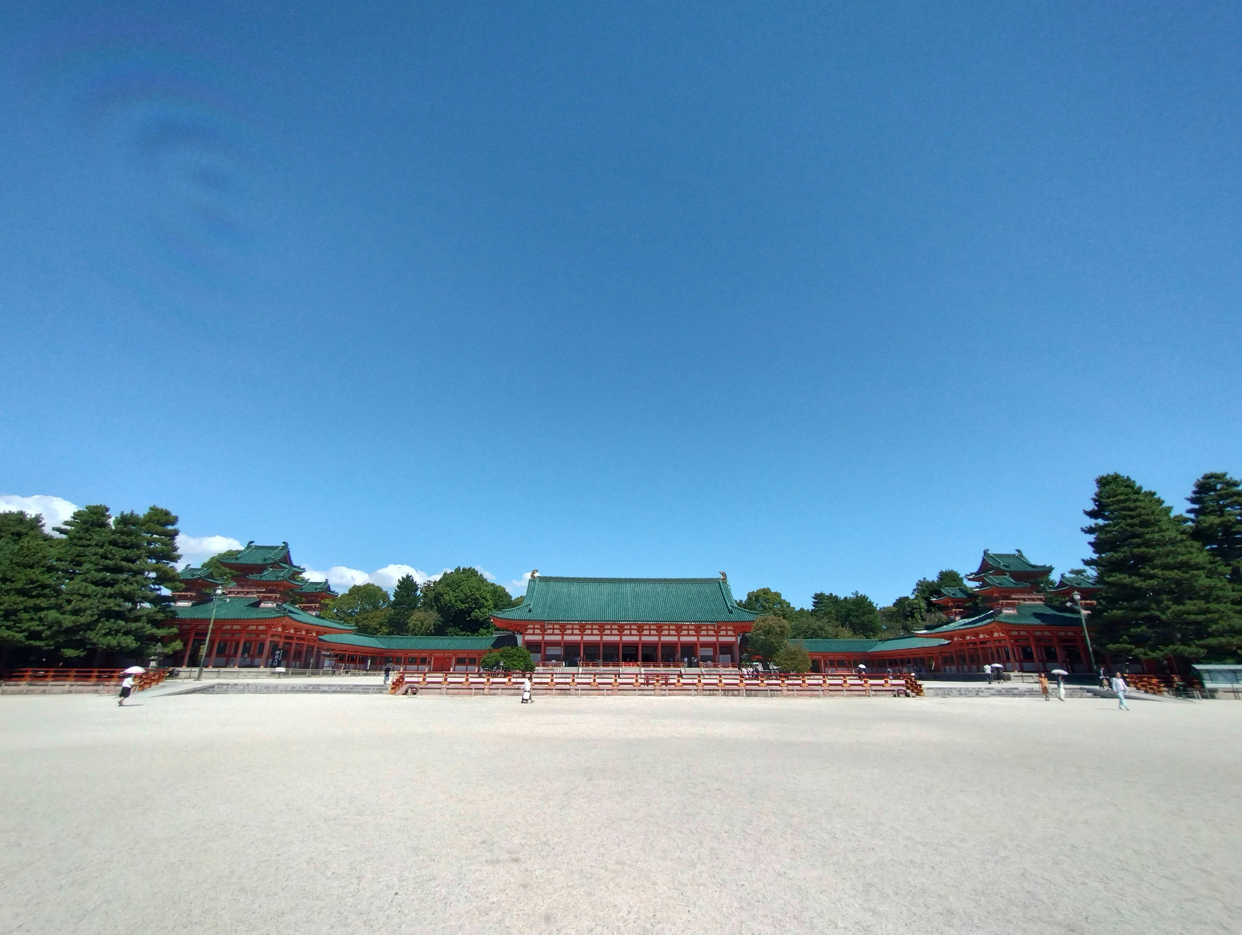 wide courtyard with traditional temple buildings under a blue sky