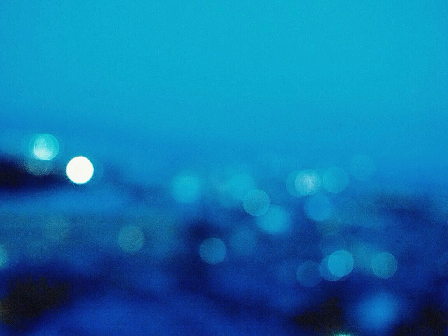 Nền xanh mờ với các phản chiếu ánh sáng mềm mại rải rác