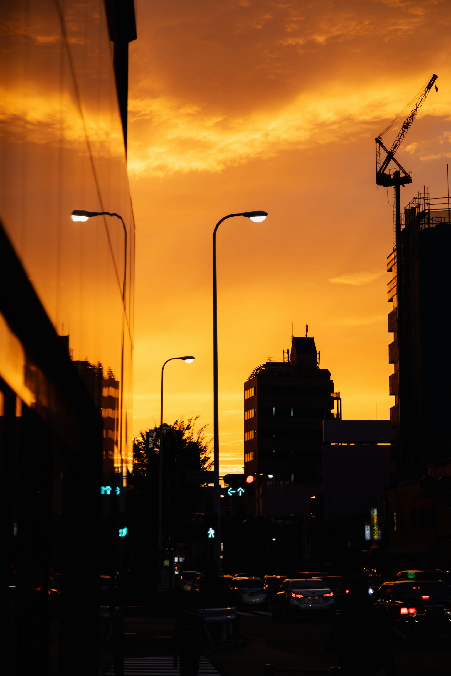 Silhouette of a city against an orange sunset sky