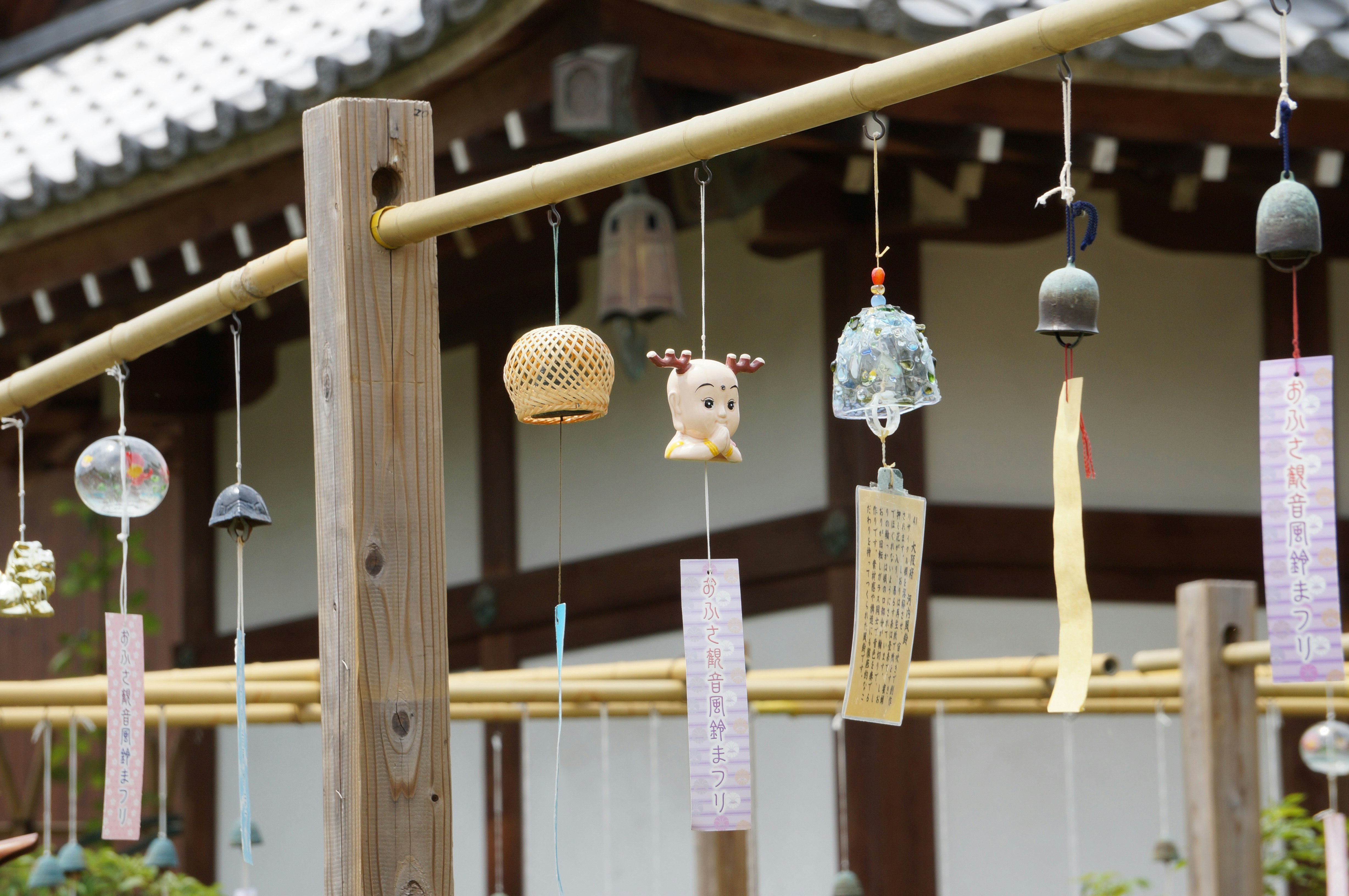 wind chimes and small hanging ornaments on a wooden eave