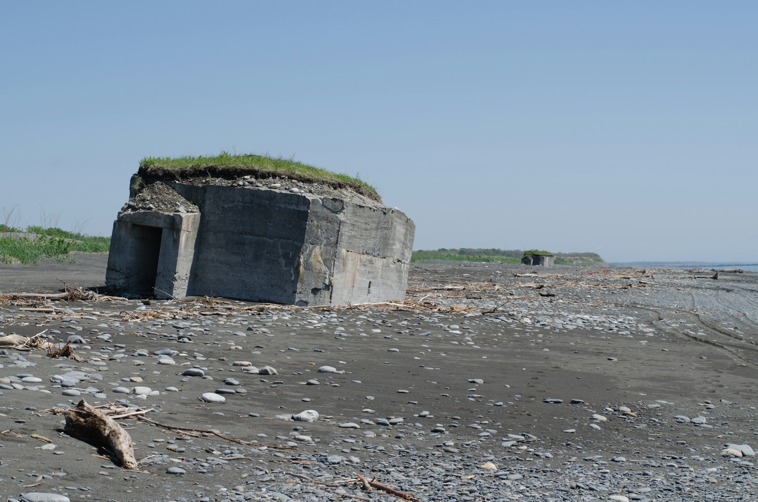 Concrete bunker on the beach with grass on top