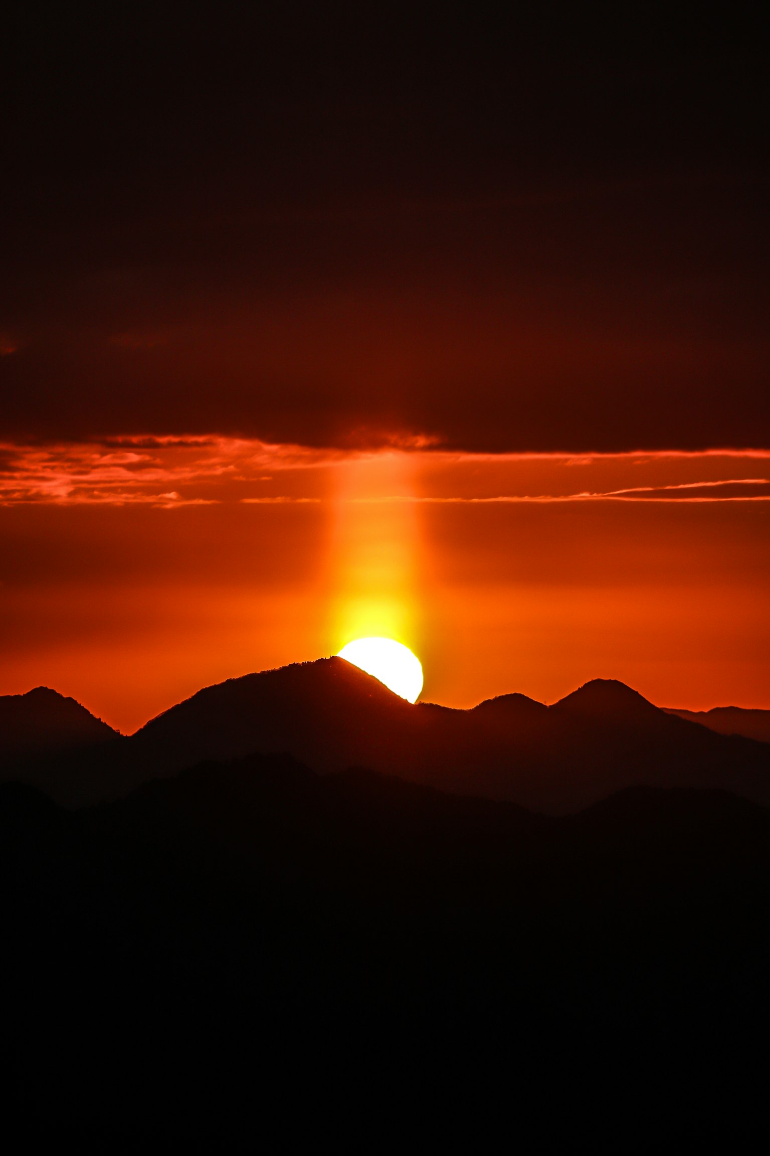 Beautiful sunset with mountain silhouettes in the background