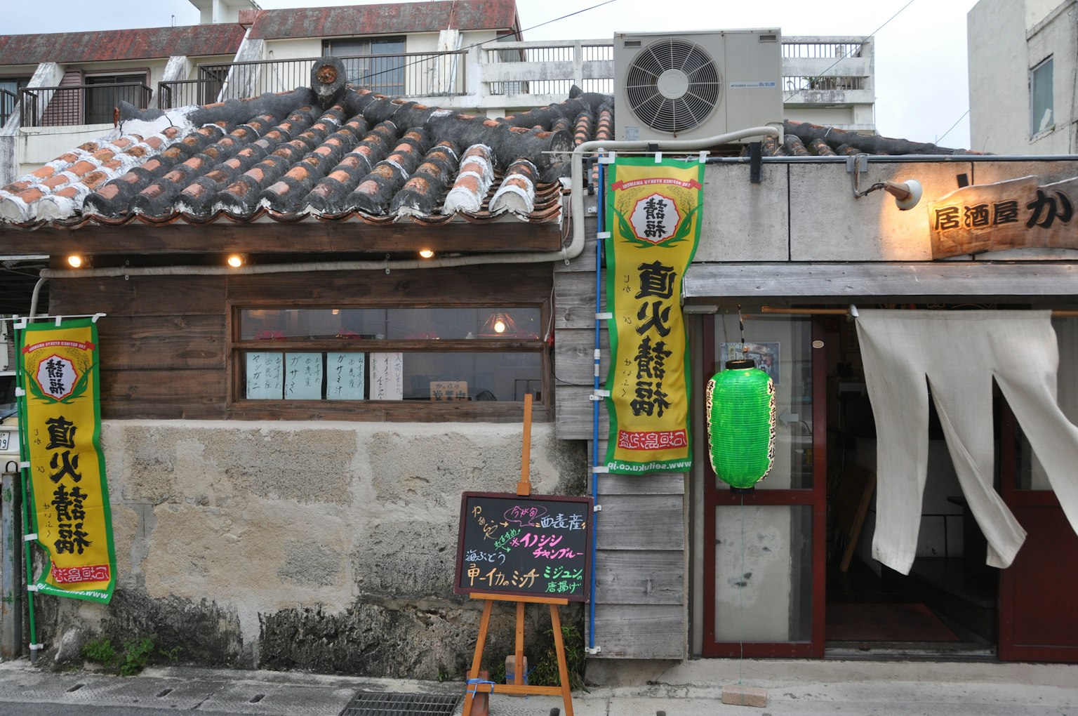 Exterior of a traditional wooden restaurant with signage