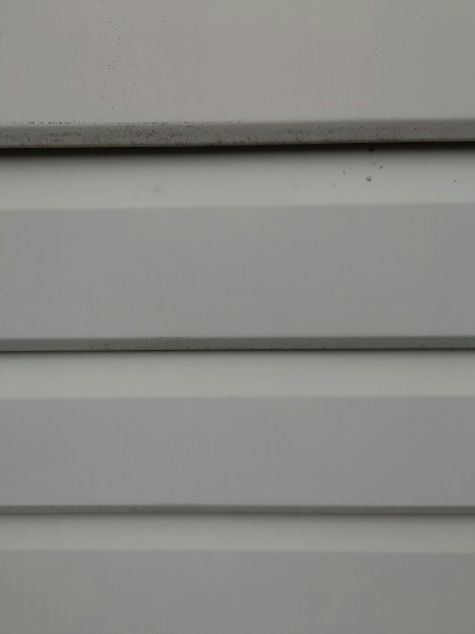 Close-up of light gray metal sliding door panels