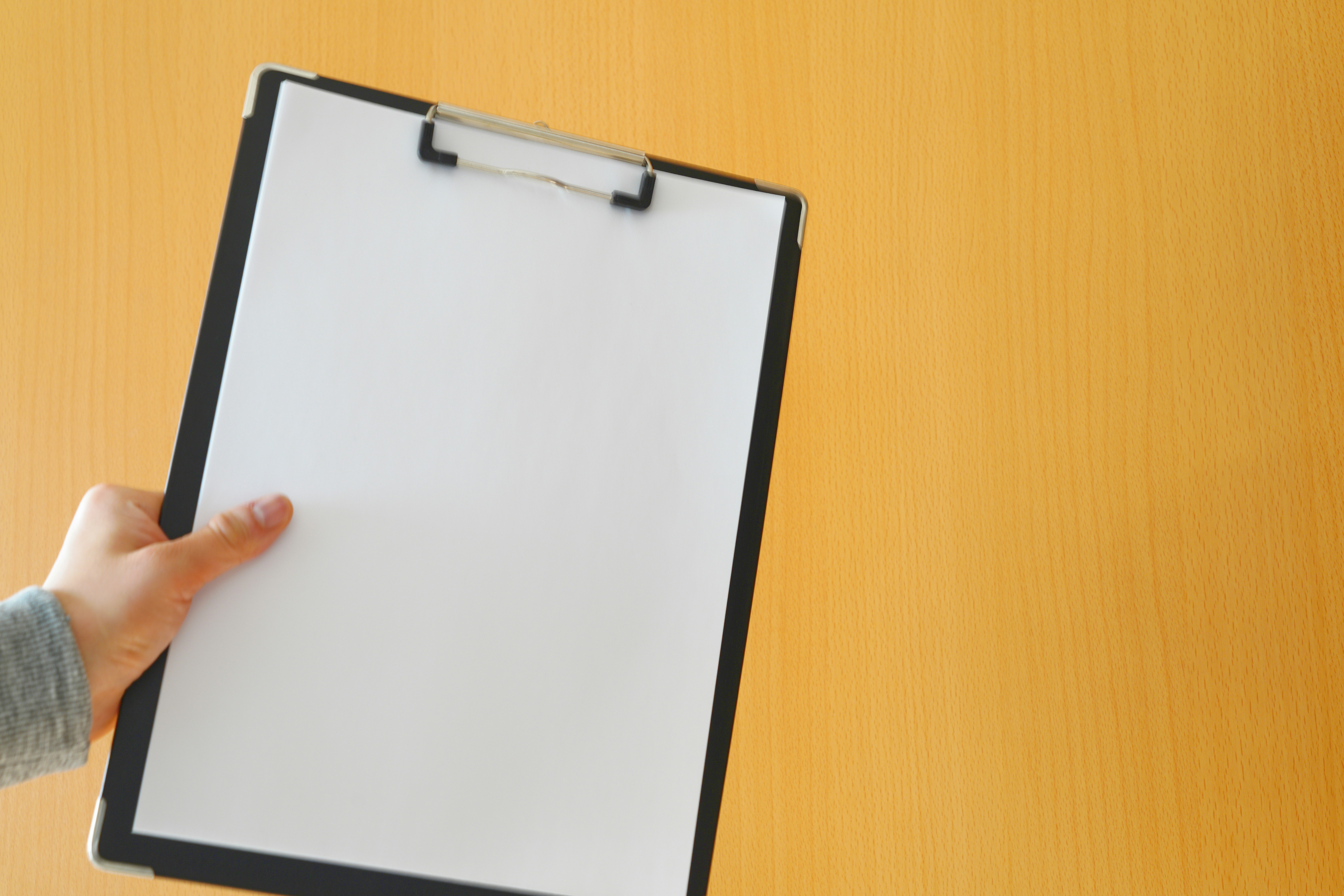 close-up of an empty clipboard held in a hand