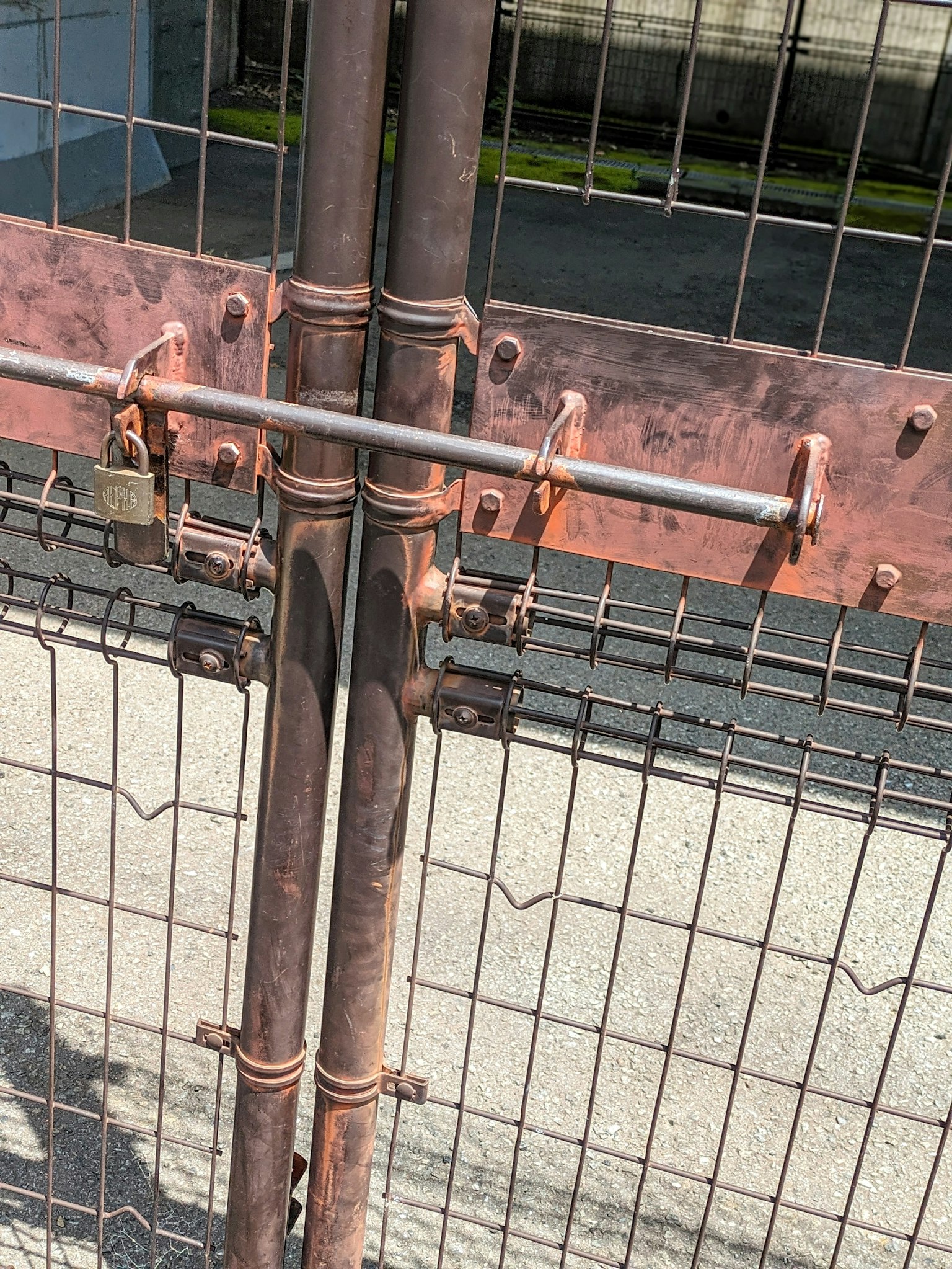 Close-up of a metal gate lock and latch details