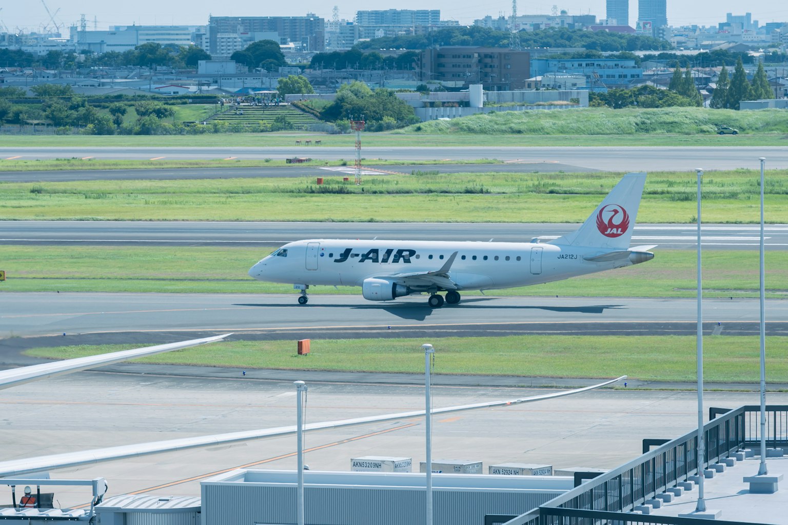 J-AIR passenger plane taxiing on the airport runway