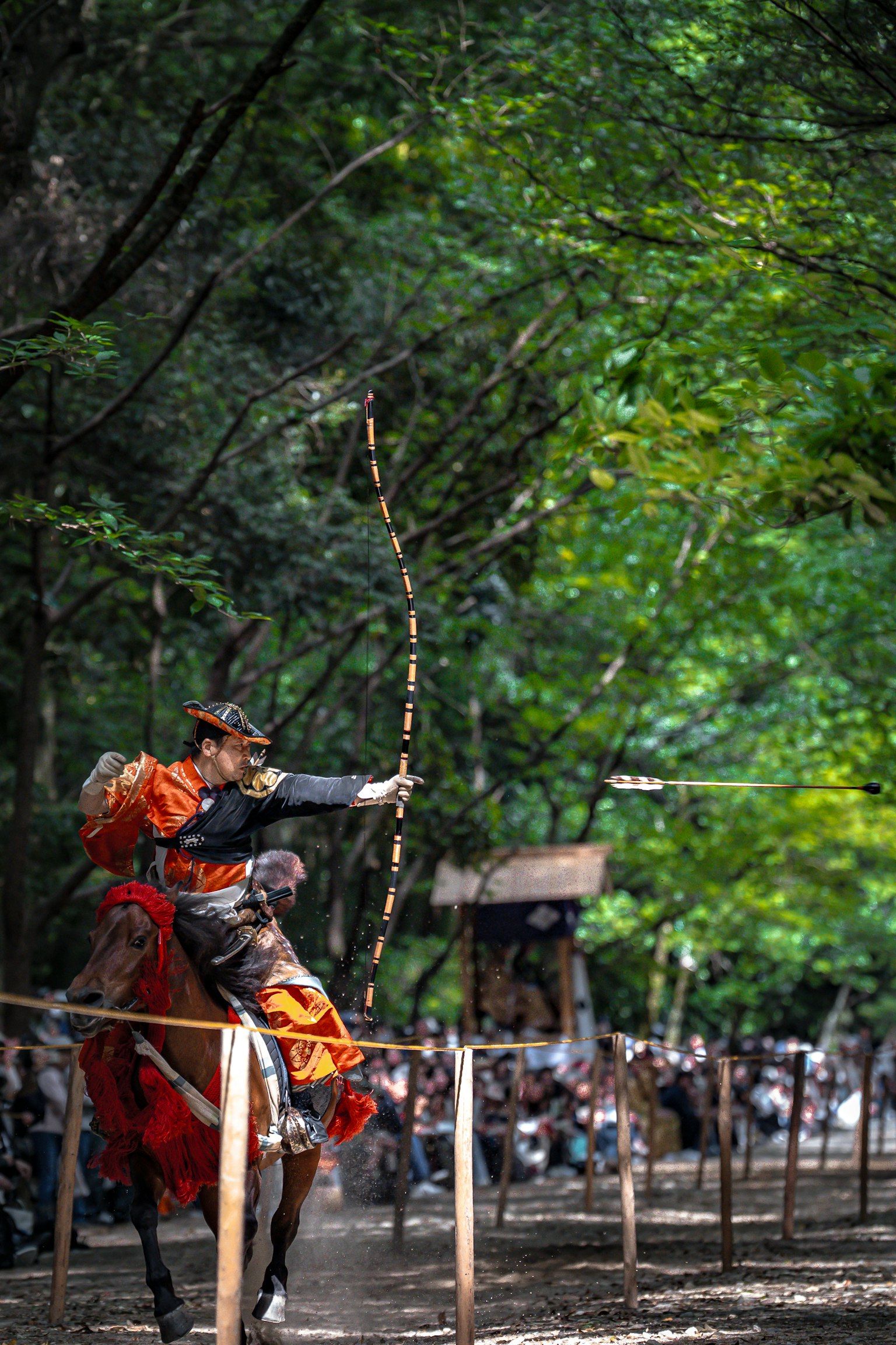 A mounted archer shooting an arrow in a lush forest setting showcasing traditional archery