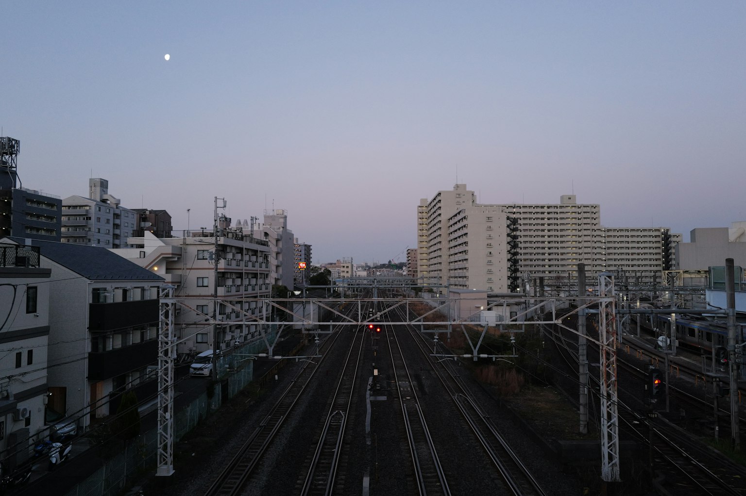 Cityscape at dusk with railway tracks