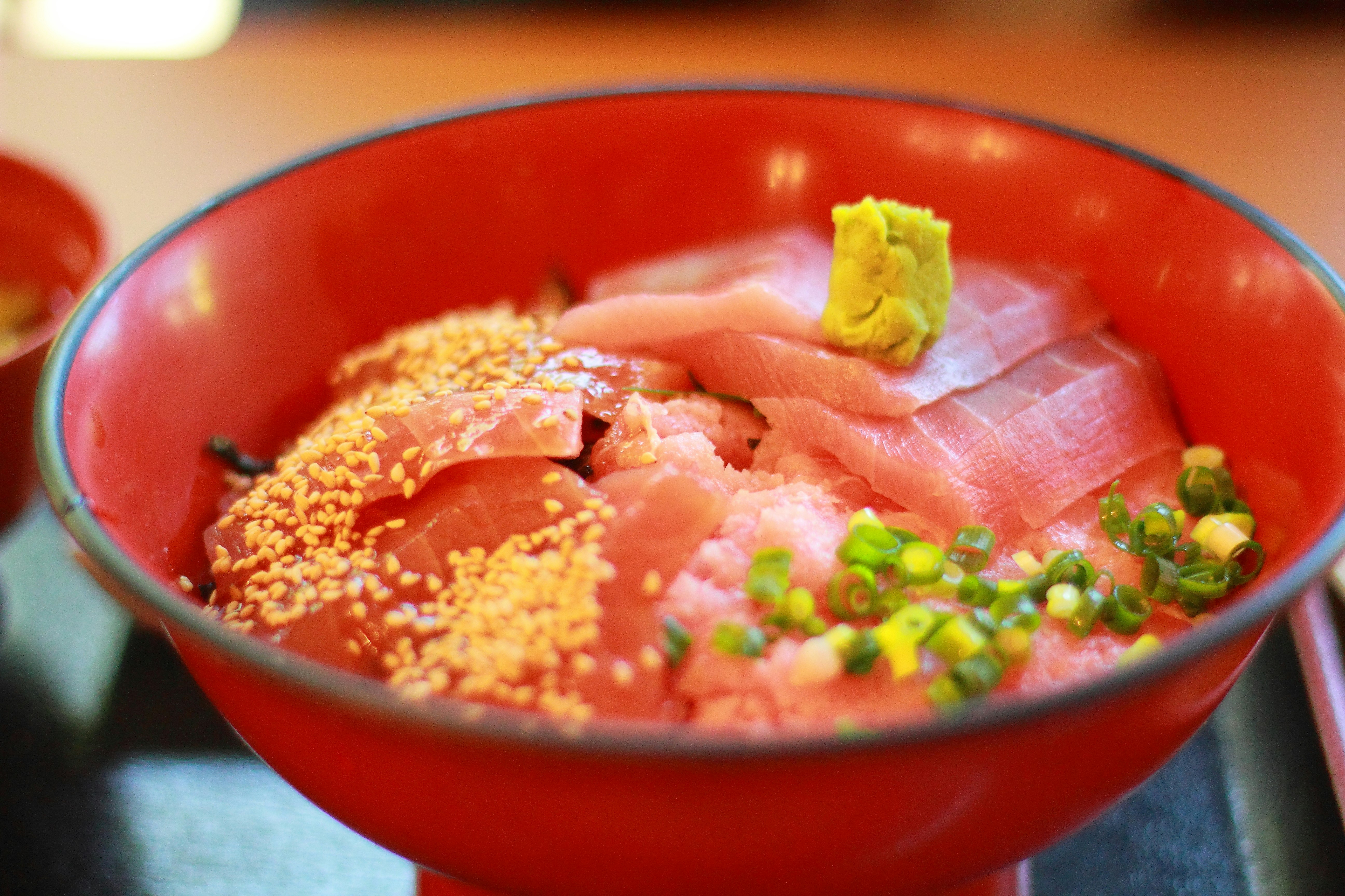 赤い丼に盛られたまぐろの海鮮丼