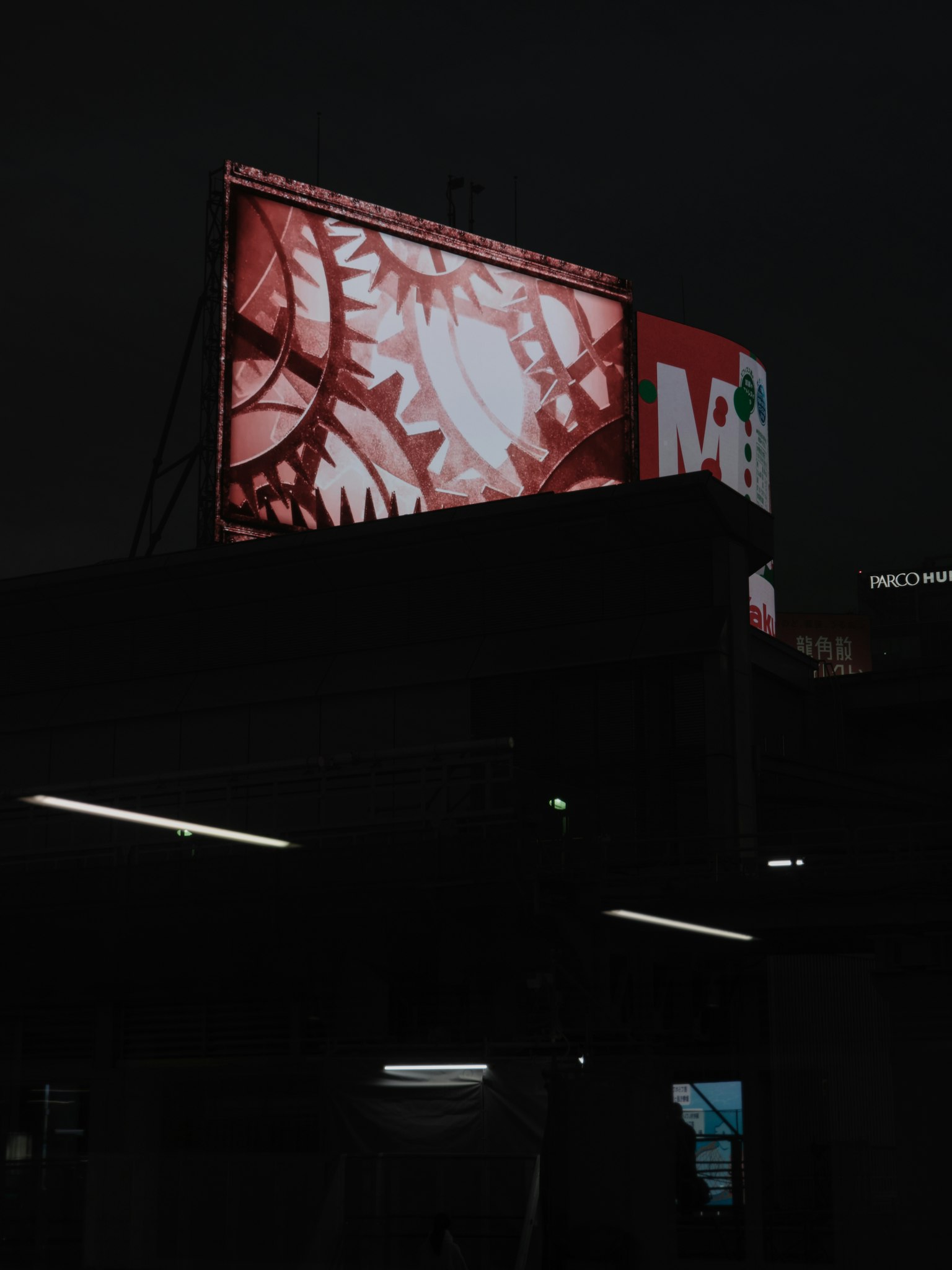 Un cartellone rosso illuminato su uno sfondo scuro