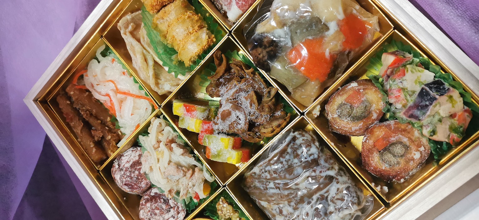 Une boîte d'osechi japonais traditionnelle remplie de plats colorés