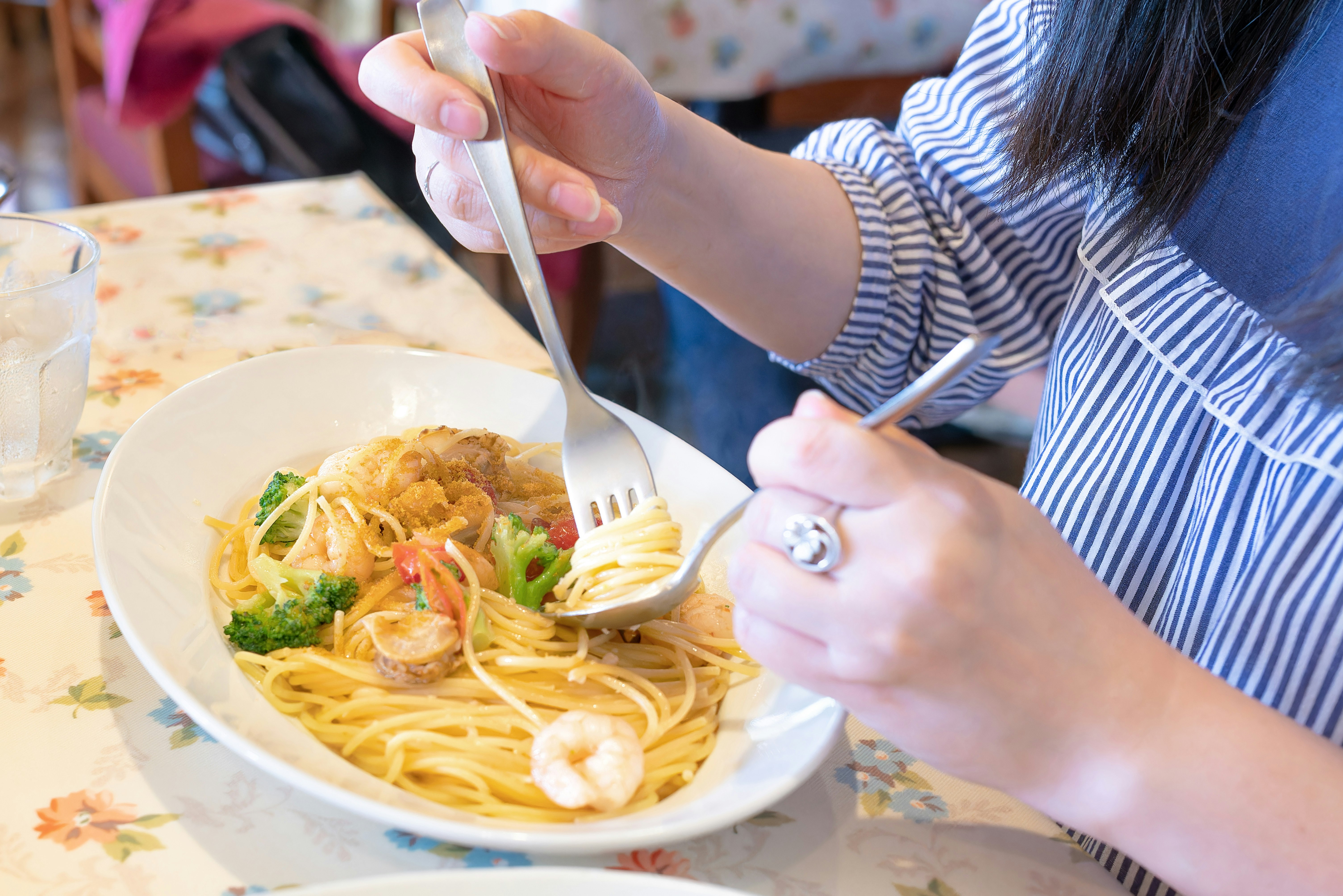 フォークでパスタを食べる手元の食卓