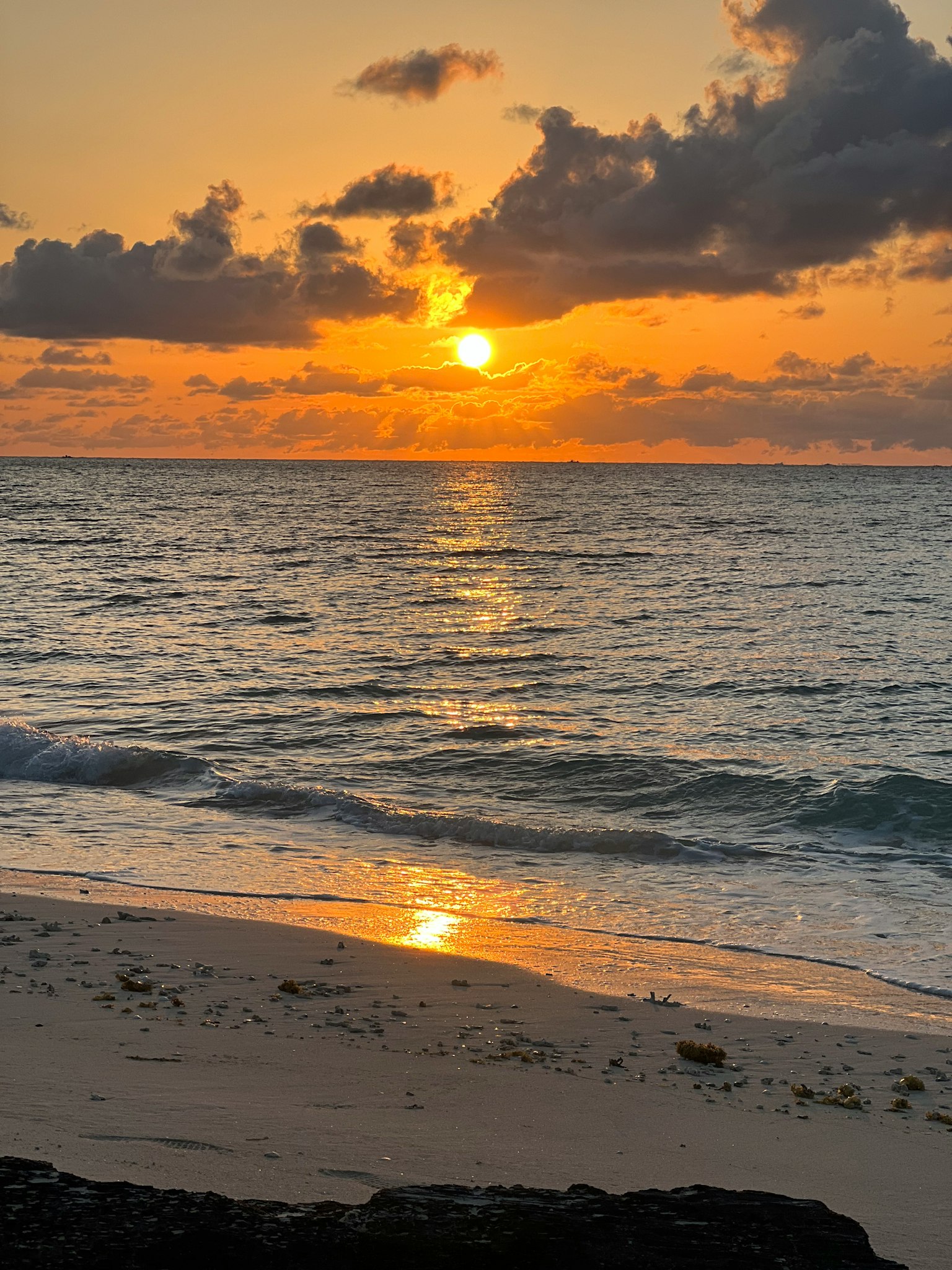 Beautiful beach scene with sunset over the ocean