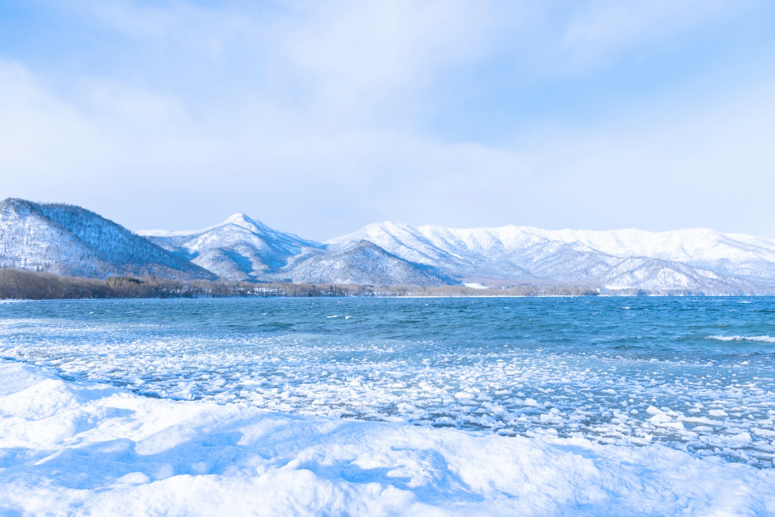 Snow-covered mountains and a blue lake landscape