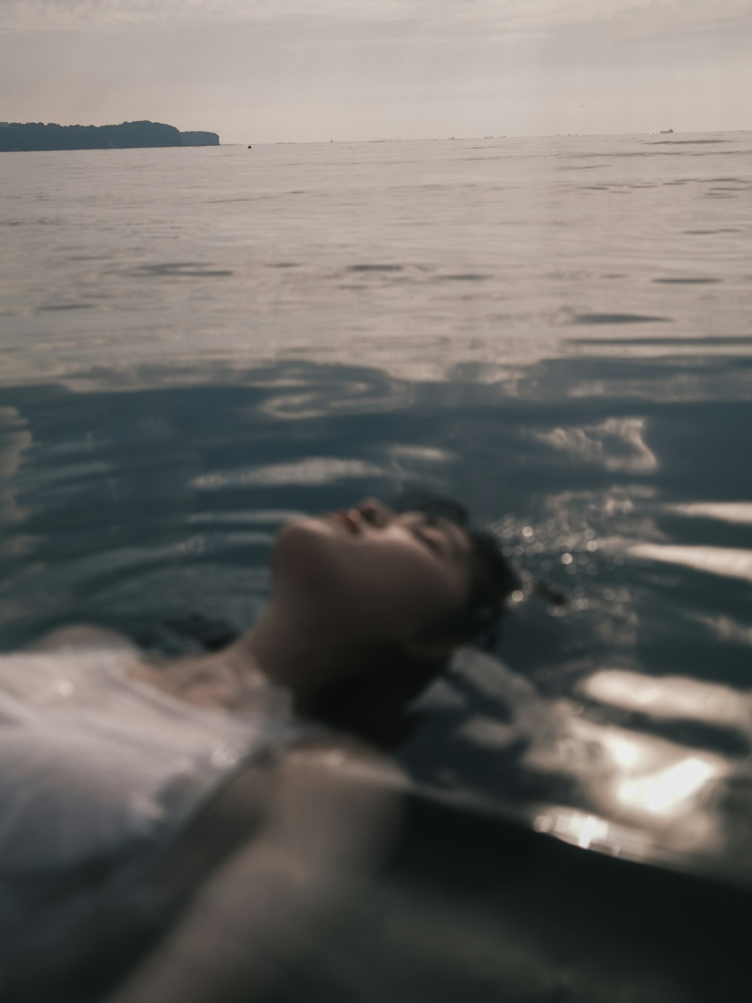 水面上漂浮的人和寧靜的海洋背景