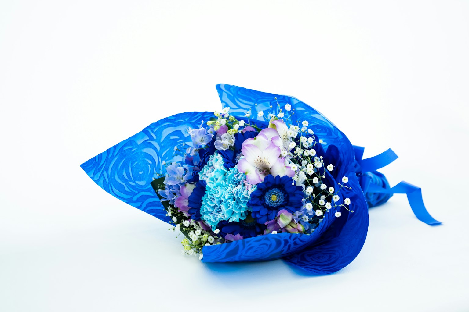 A blue bouquet featuring purple and white flowers