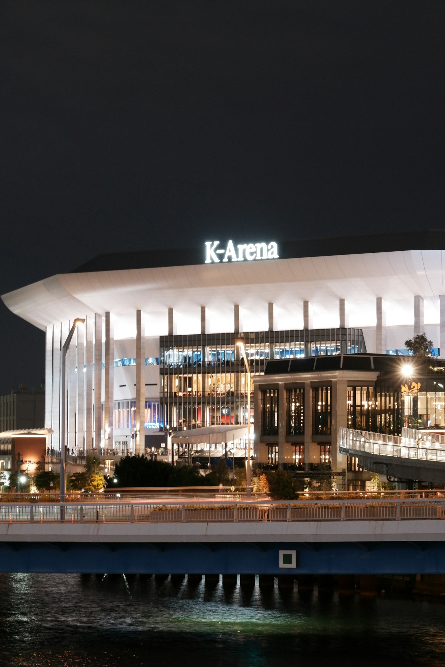 Night view of K-Arena showcasing modern architectural design