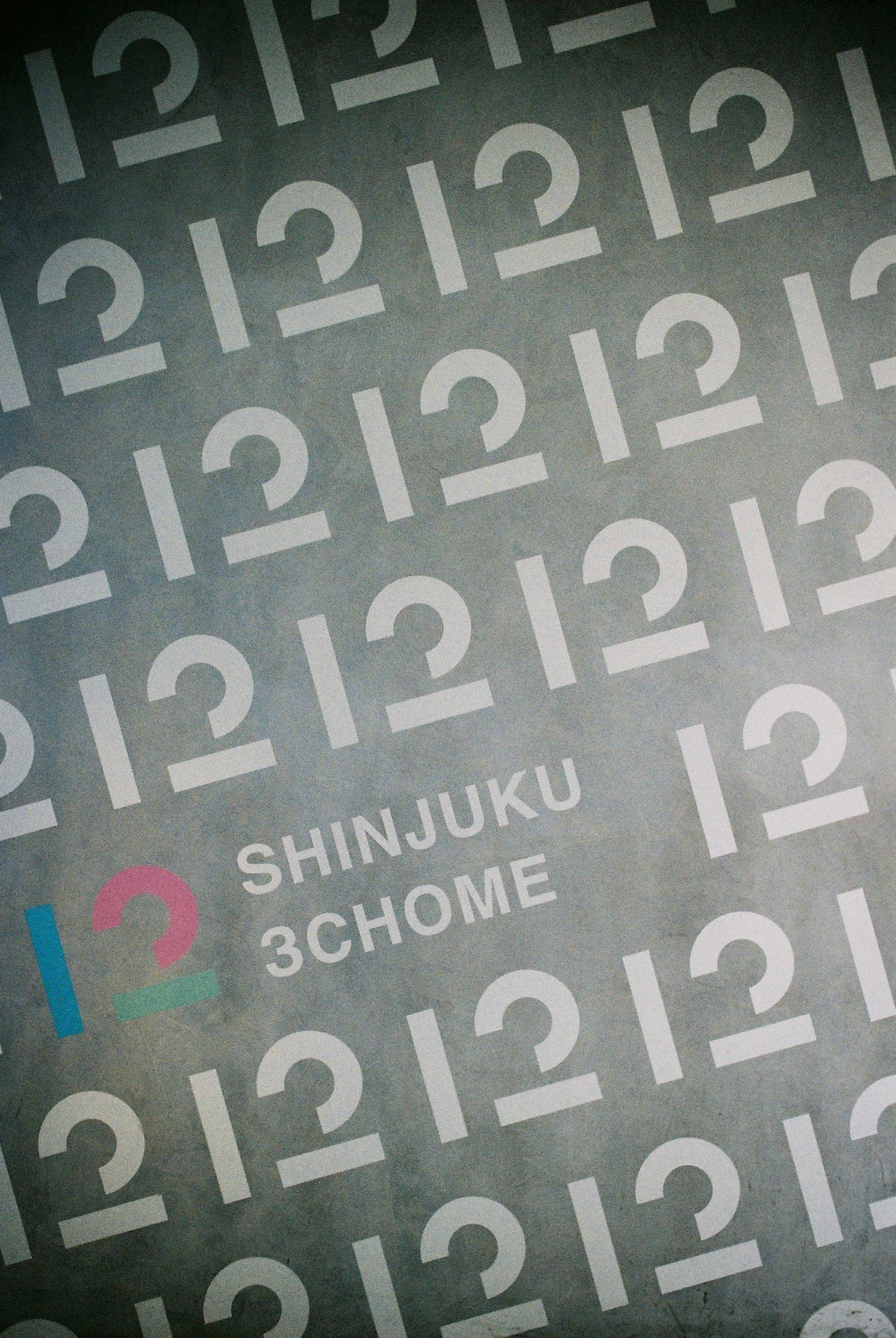 Background featuring a pattern of numbers with the text Shinjuku 3chome