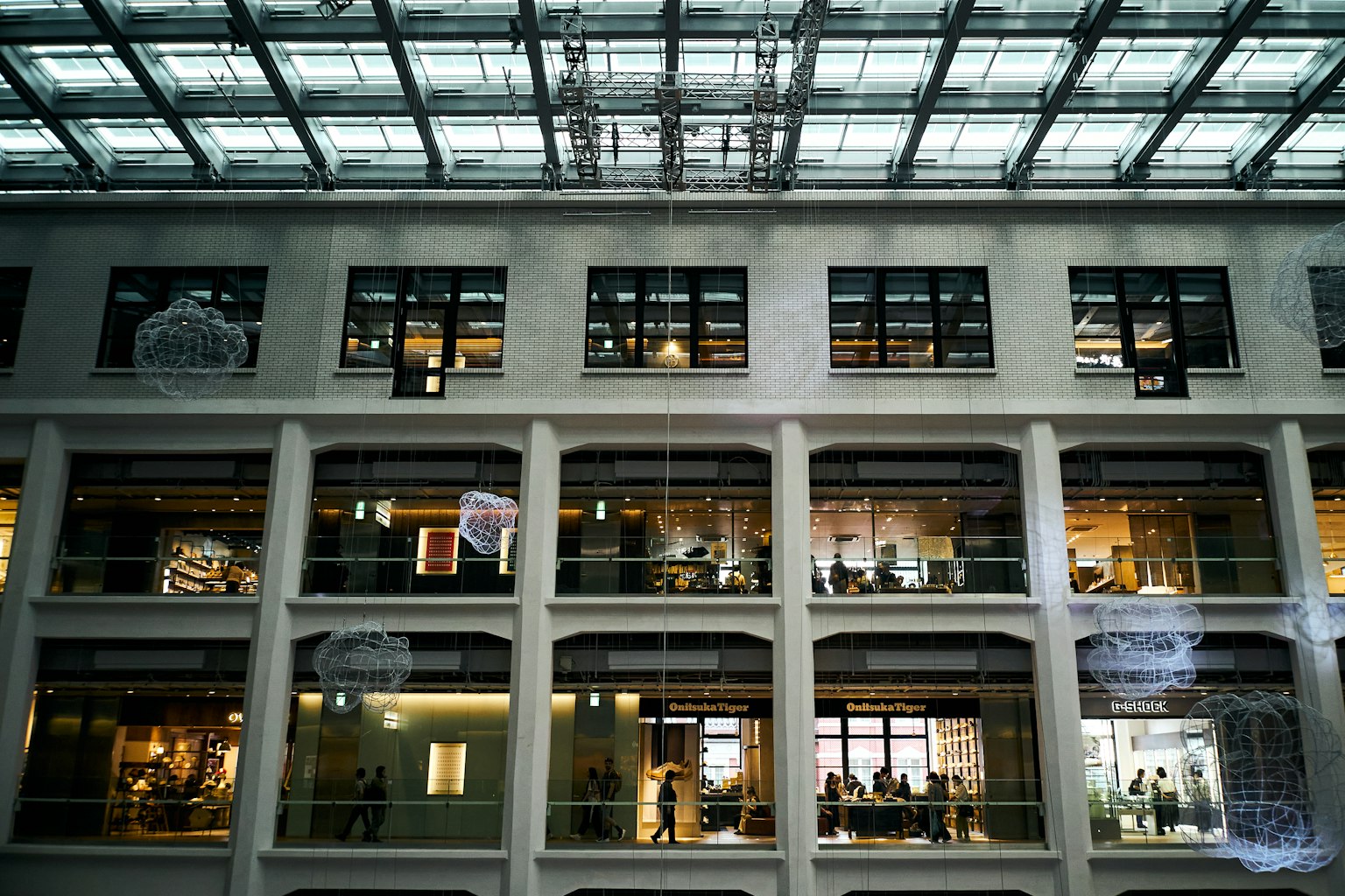 Tampilan interior gedung modern dengan jendela besar dan atap kaca