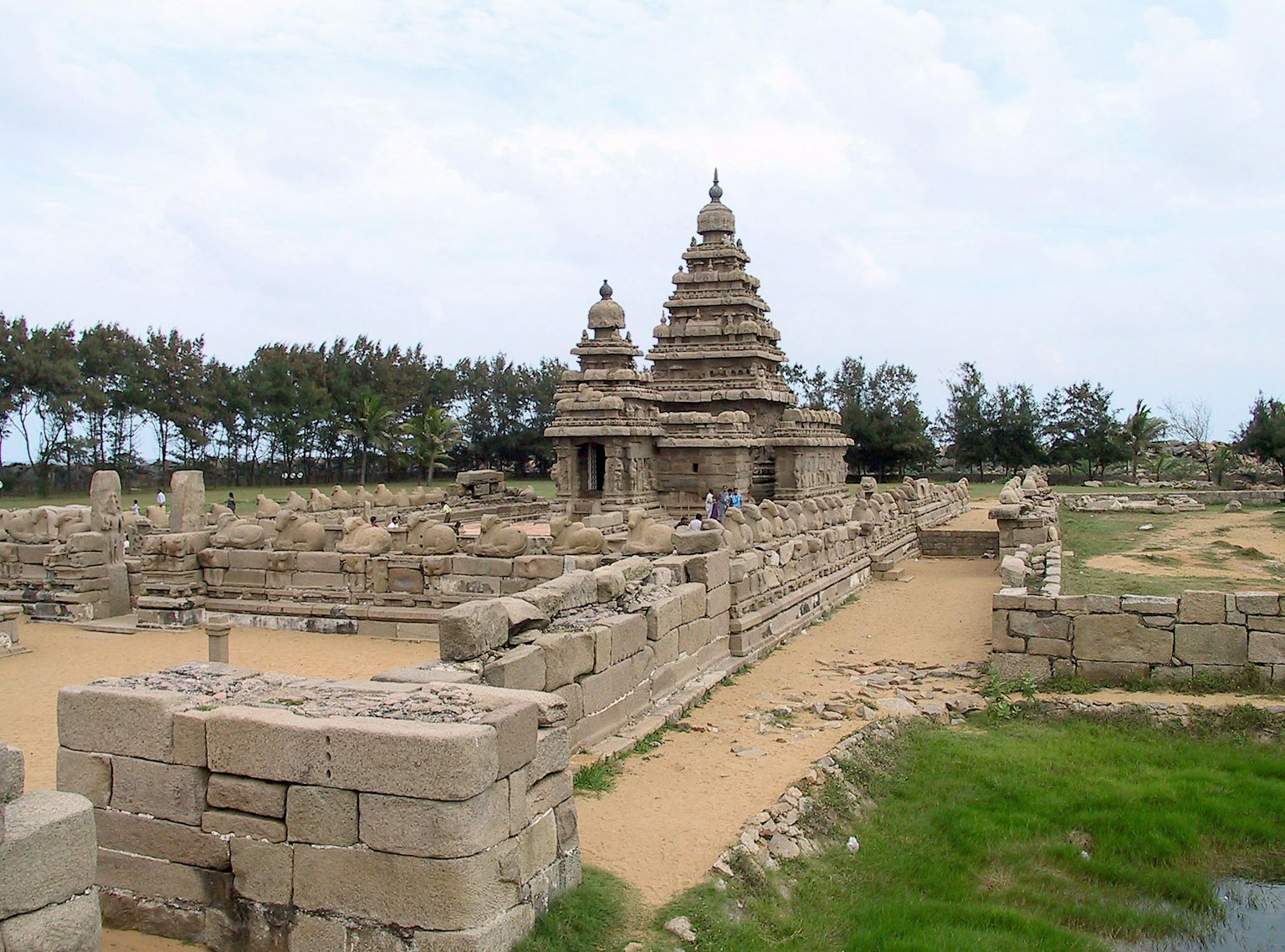 Ruines d'un ancien temple avec une végétation luxuriante en arrière-plan