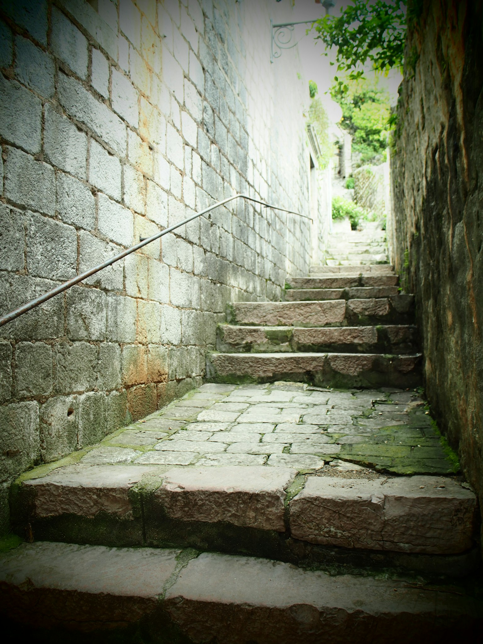 Narrow alleyway with stone steps leading upwards
