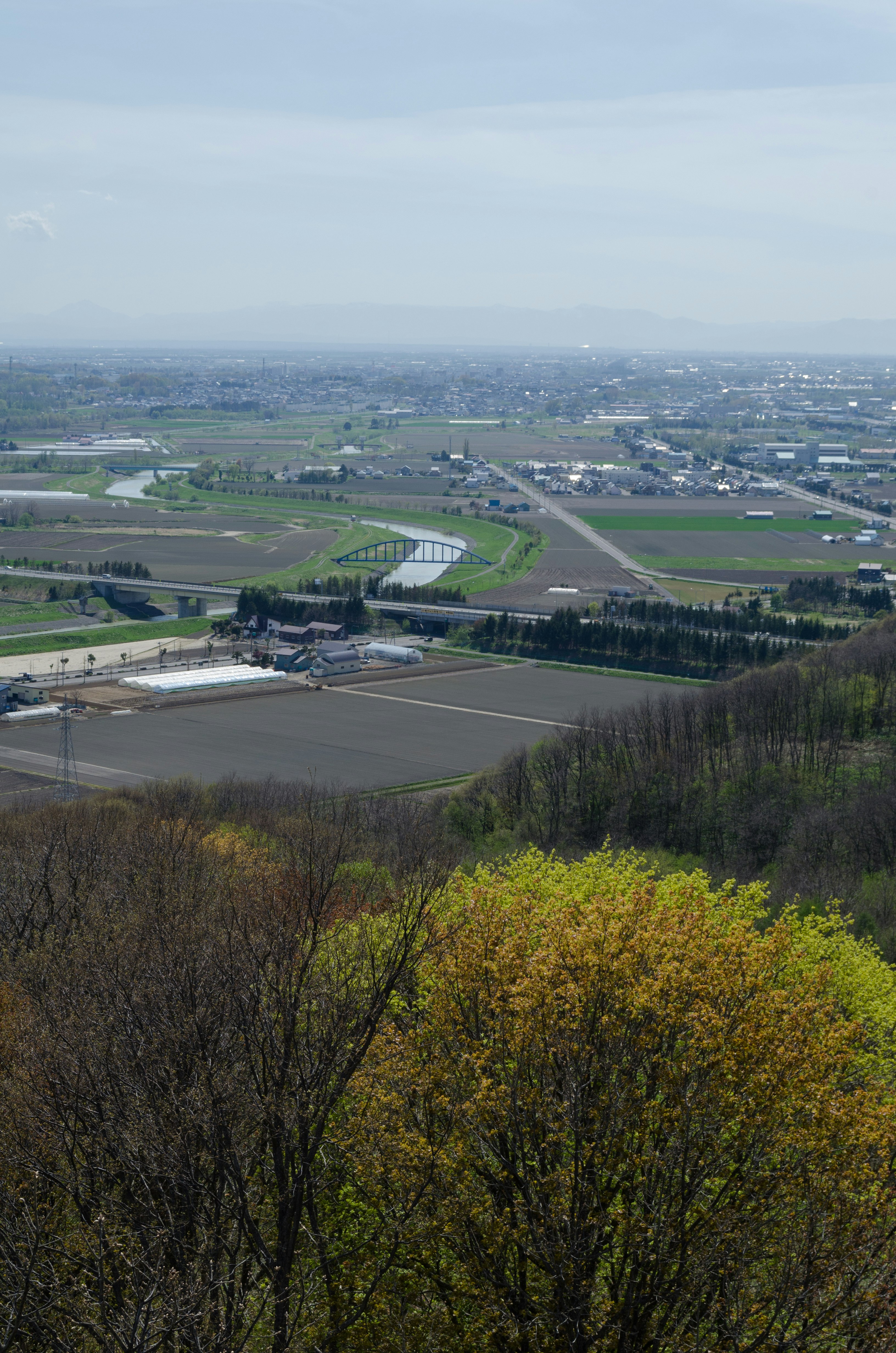 Overlook of fields and a river from a hillside