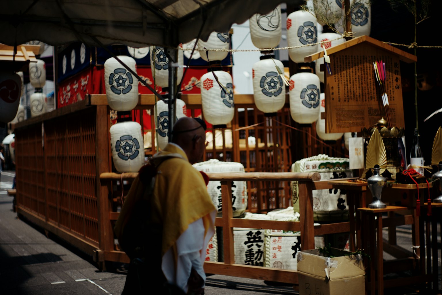 Traditional Japanese stall adorned with lanterns and a monk