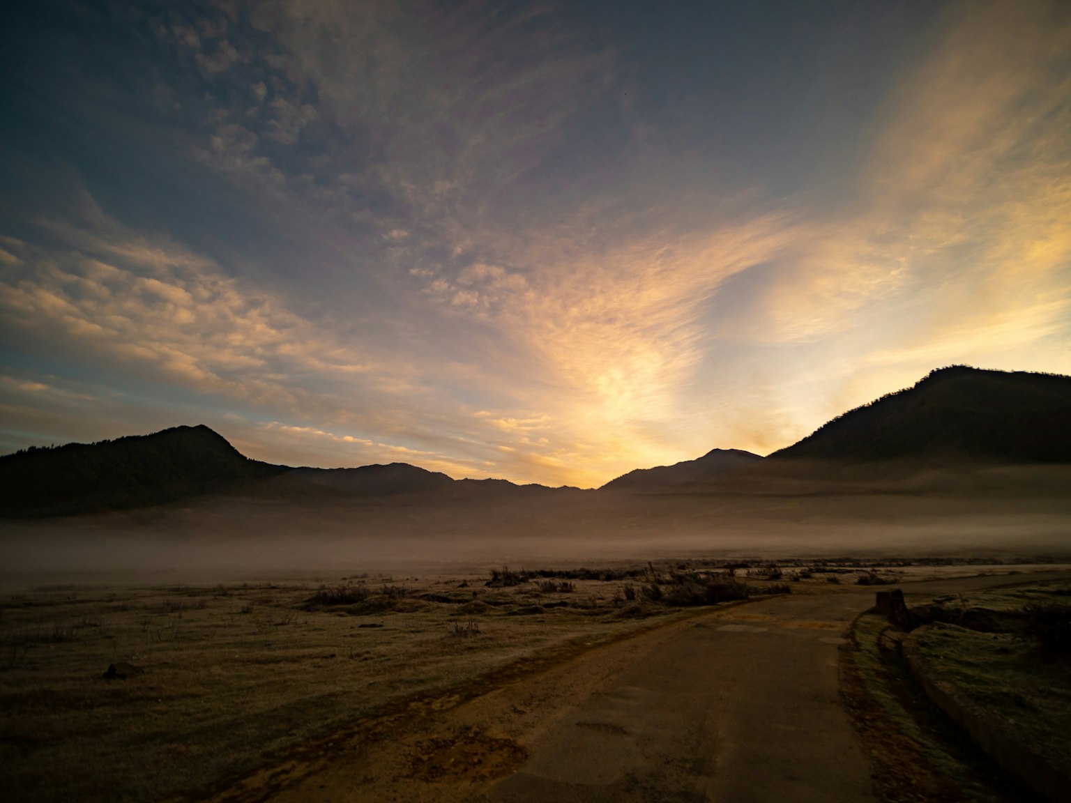Mountains shrouded in mist with a beautiful sunset sky