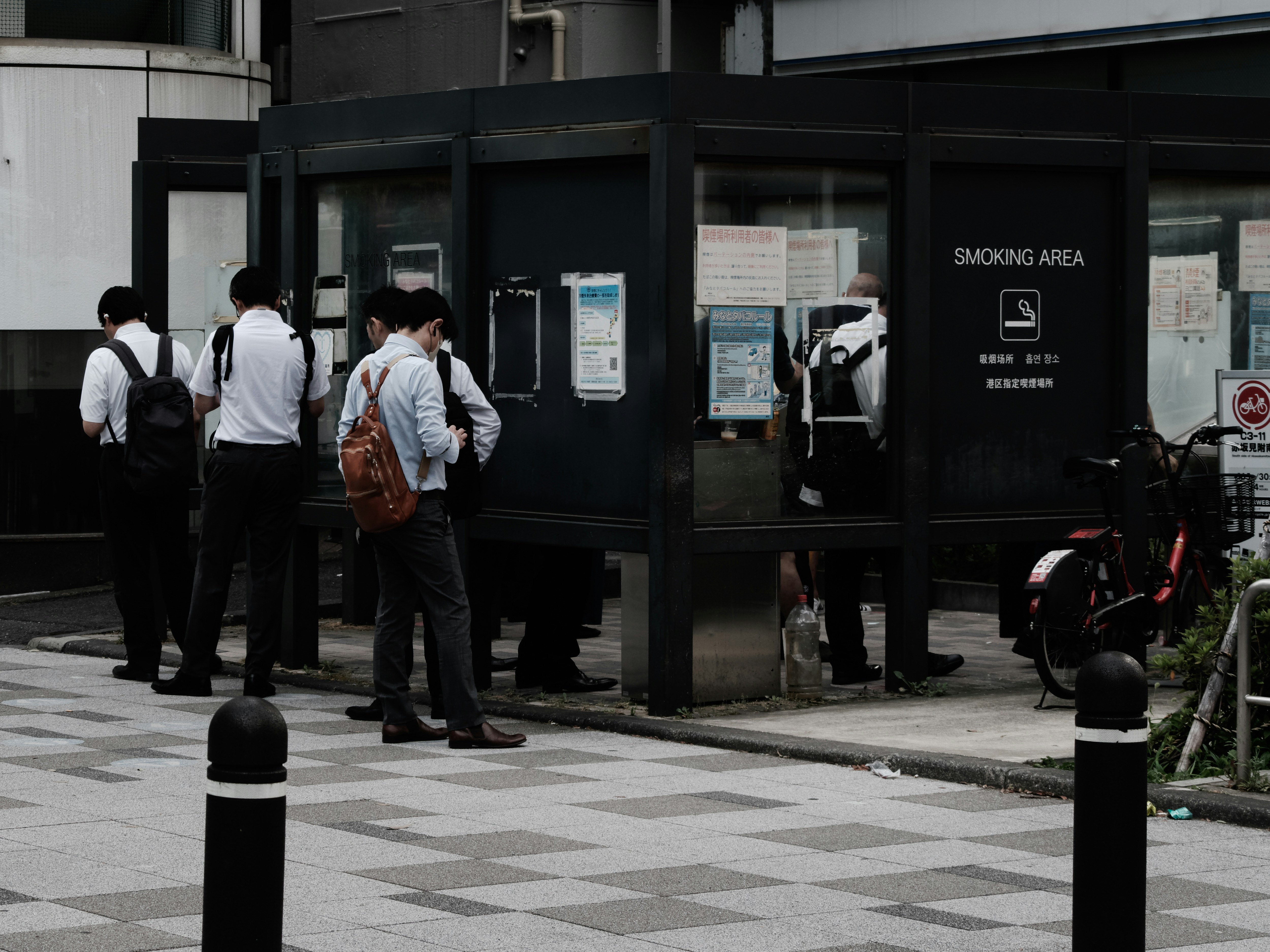 outdoor street corner with a smoking area sign