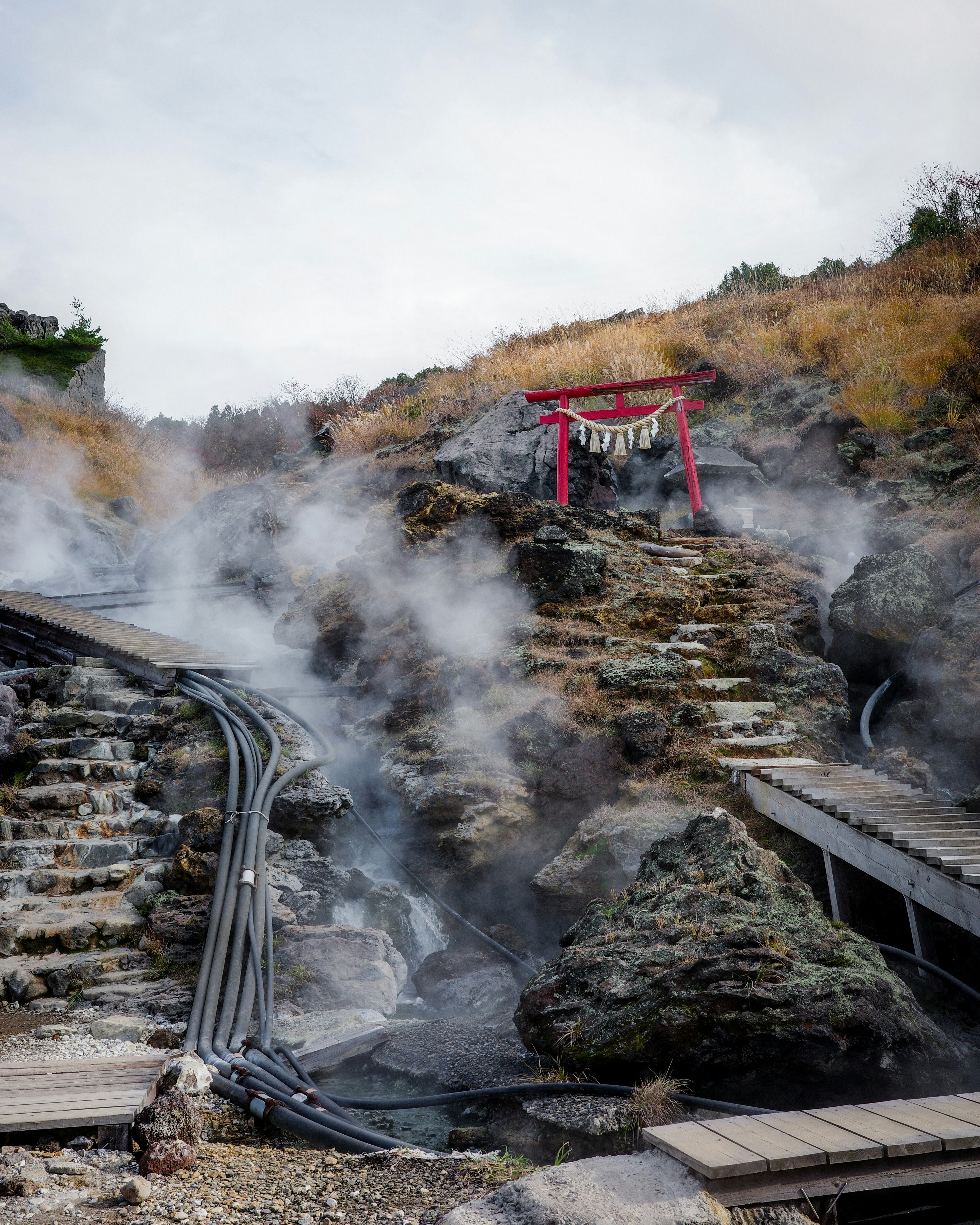 岩石溫泉設施的棧道與管道冒著蒸汽