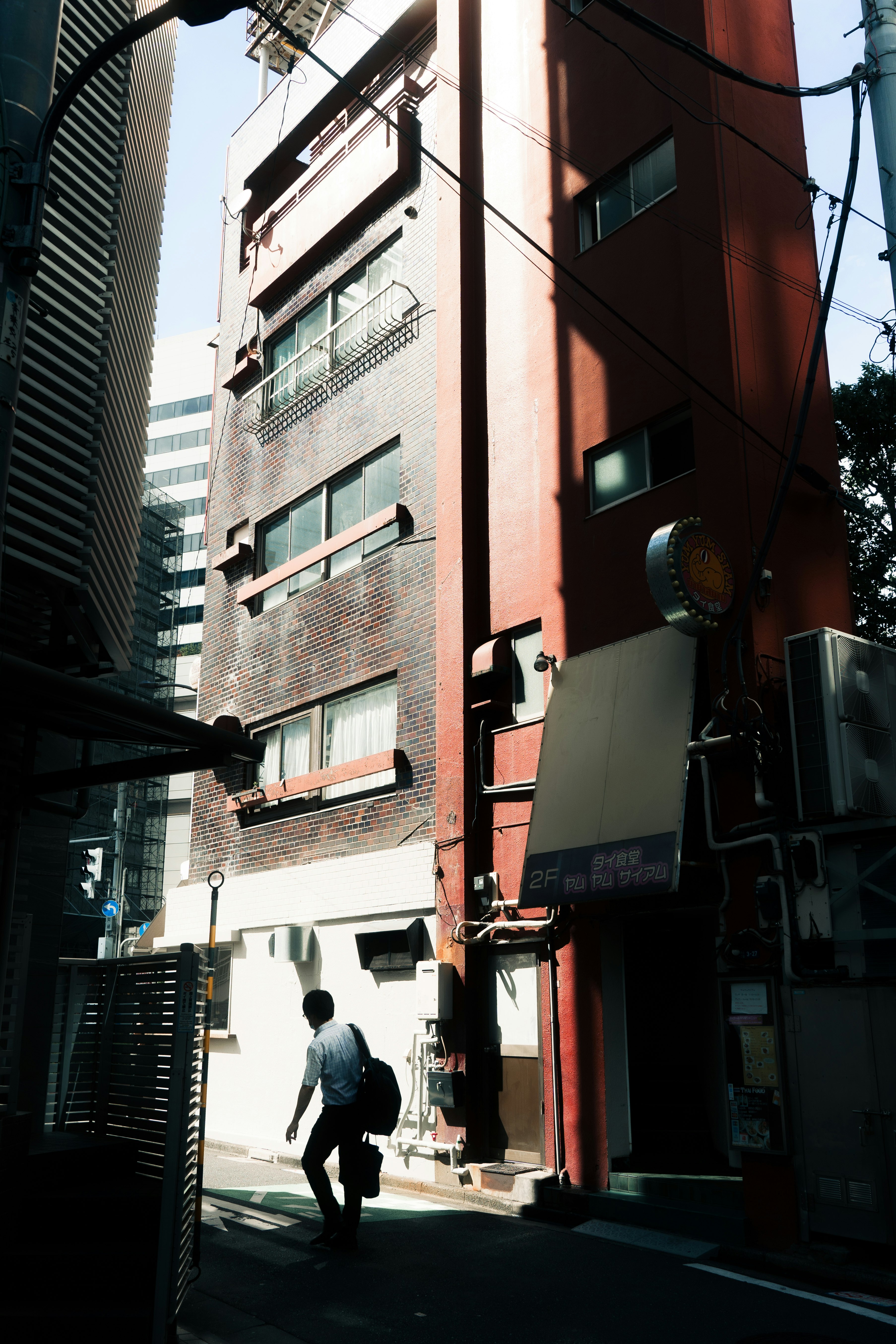 urban alley with tall buildings and a pedestrian