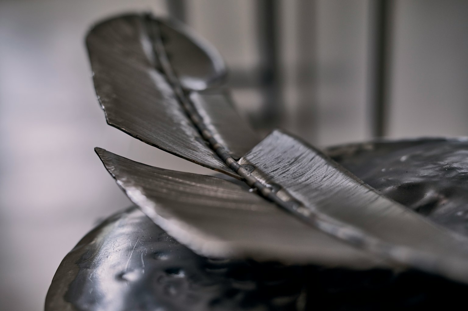 Close-up of a metal sculpture featuring curved and angular shapes