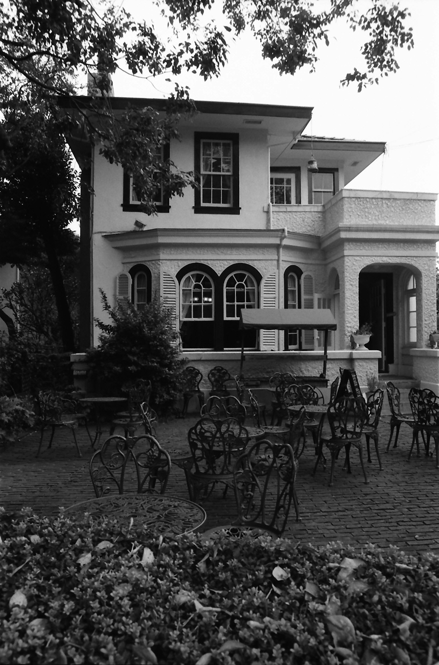 Immagine in bianco e nero di una bella casa con posti a sedere nel giardino