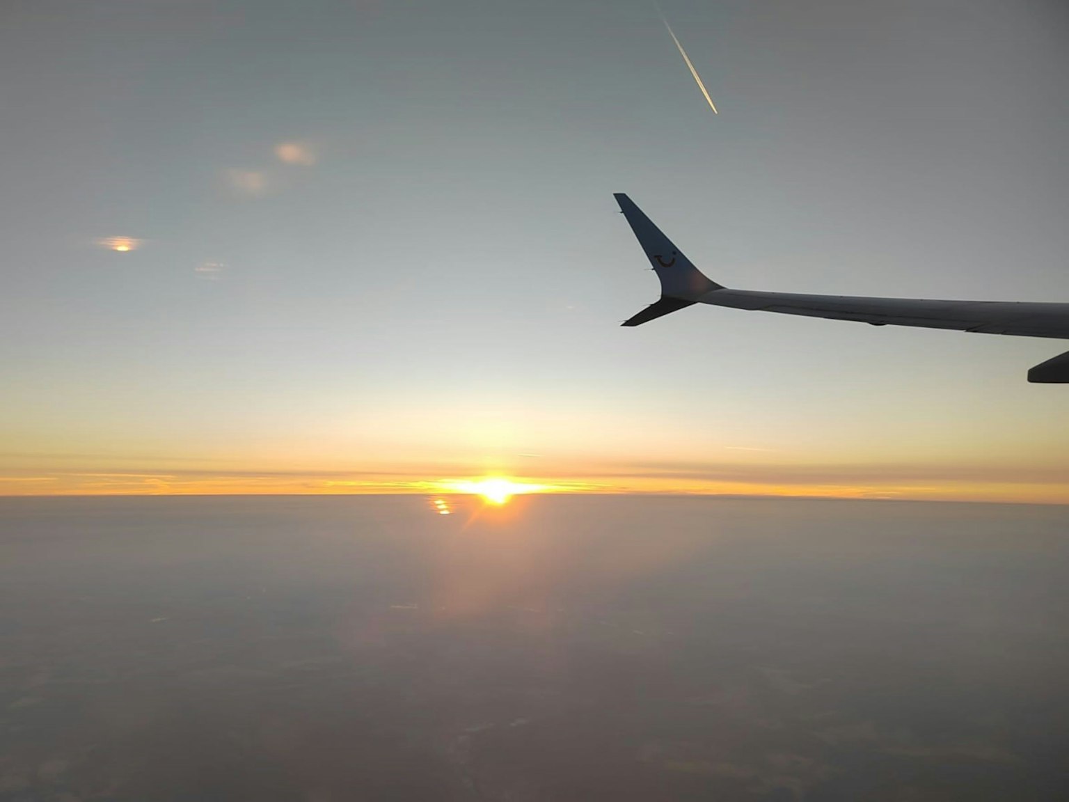 Airplane wing against a beautiful sunset sky